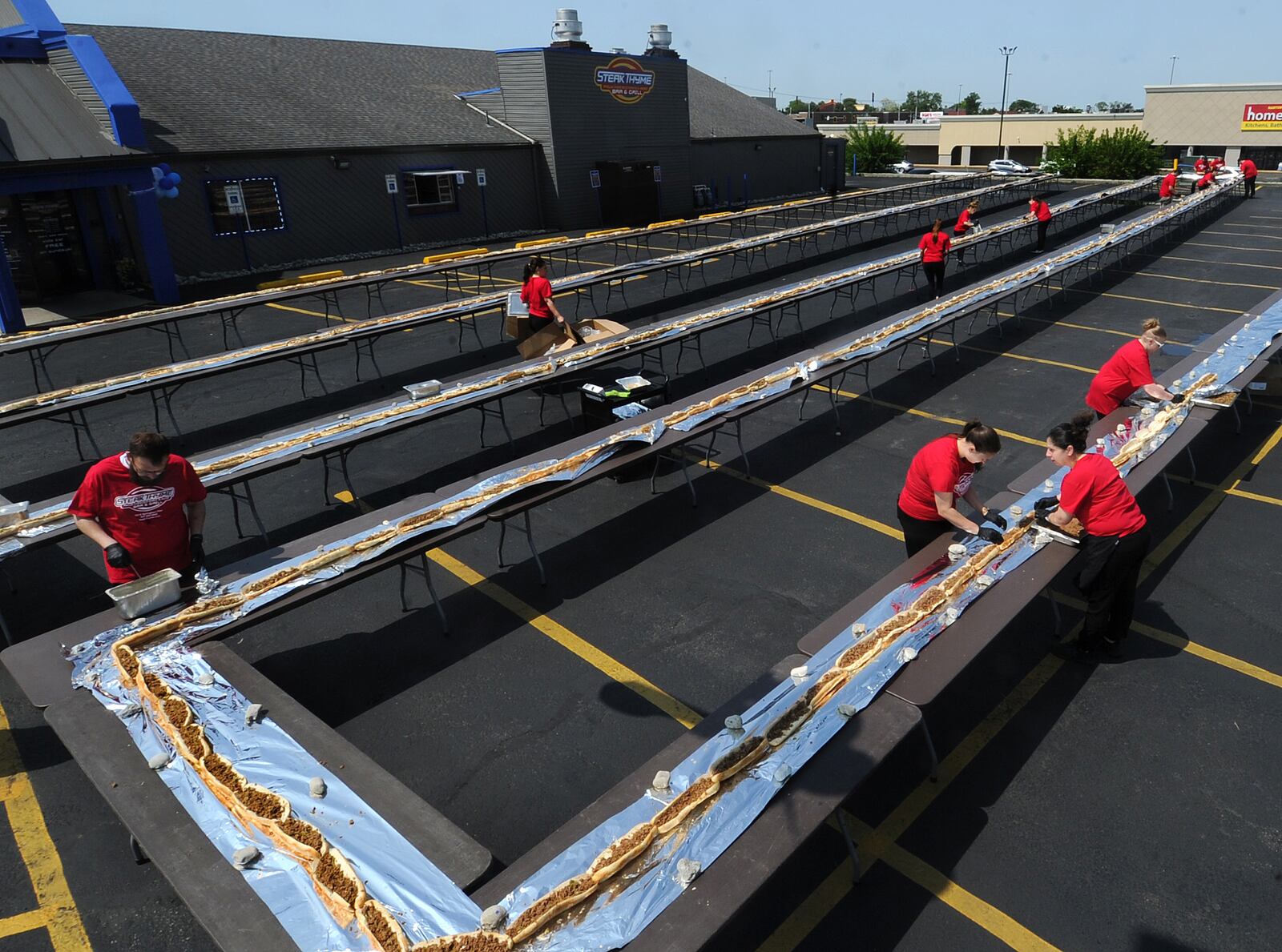 Steak Thyme Bar & Grill at 103 N. Springboro Pike in Miamisburg celebrated its first anniversary Wednesday, May 17, 2023, in a big way by constructing a 650.3-foot-long cheesesteak to the world record. MARSHALL GORBY\STAFF