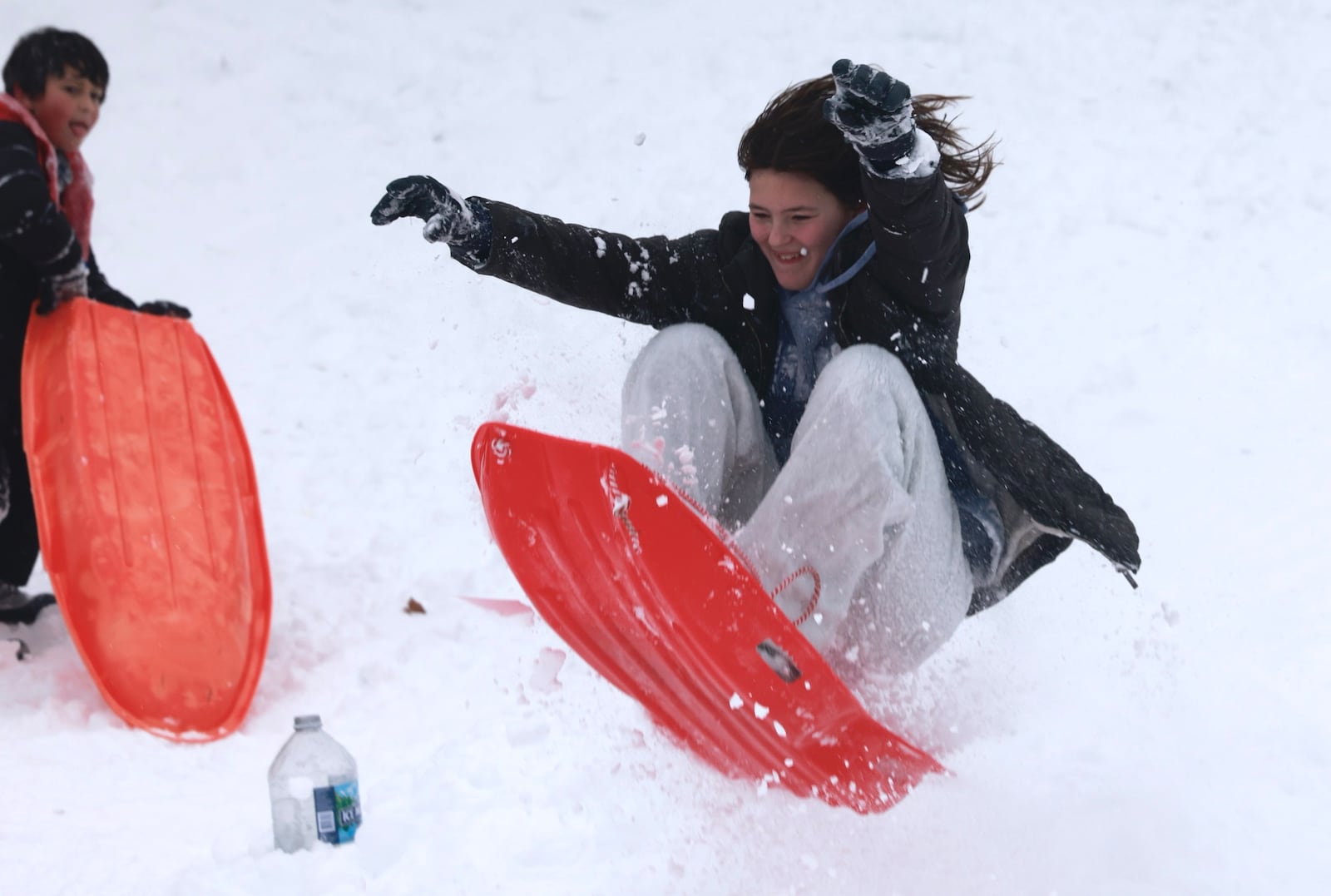 Instead of going back to school Monday, Jan. 6, 2025, a group of kids were having fun sledding at a park near Dayton. BILL LACKEY/STAFF