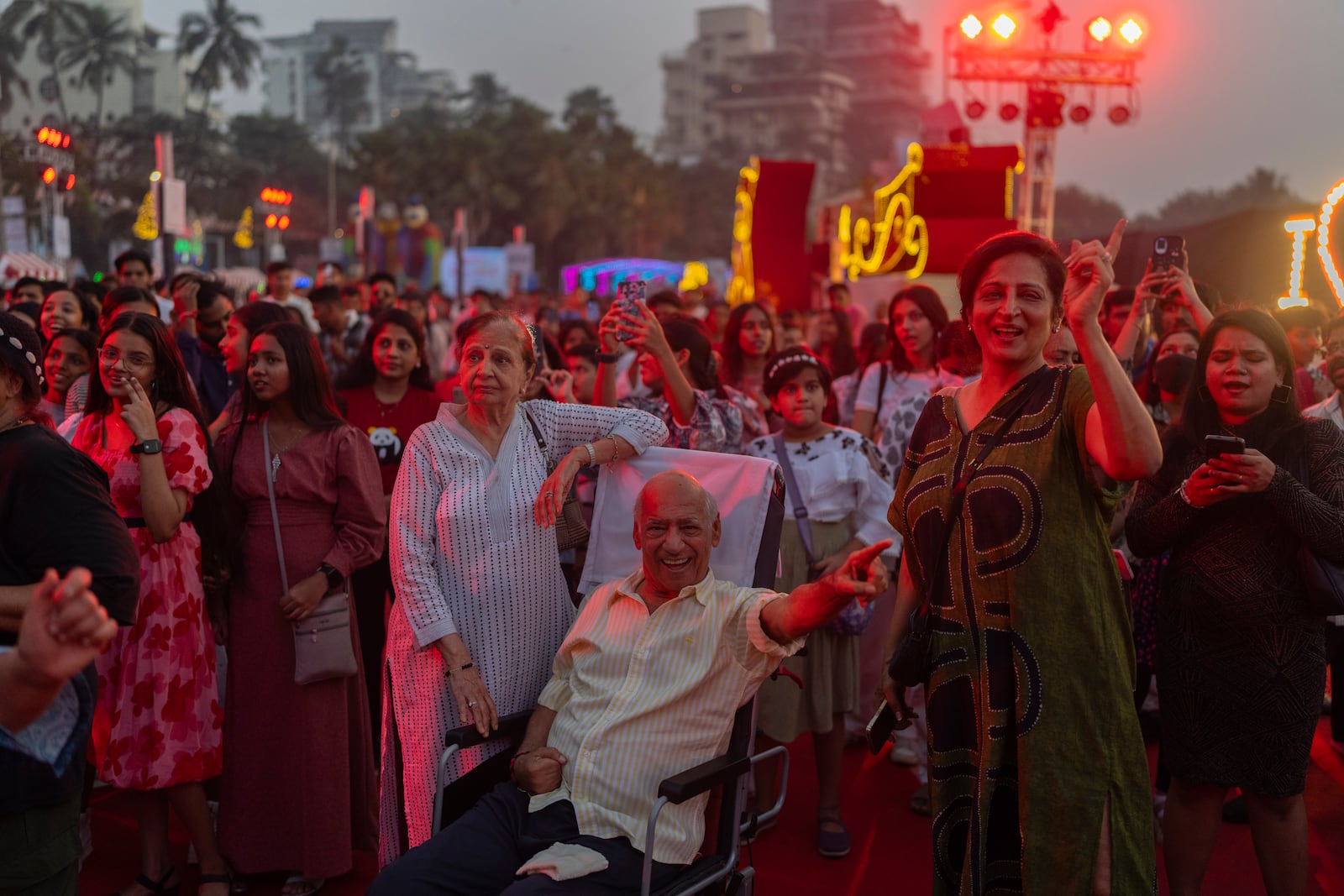 People celebrate New Year’s Eve at a promenade in Mumbai, India, Tuesday, Dec. 31, 2024. (AP Photo/Rafiq Maqbool)