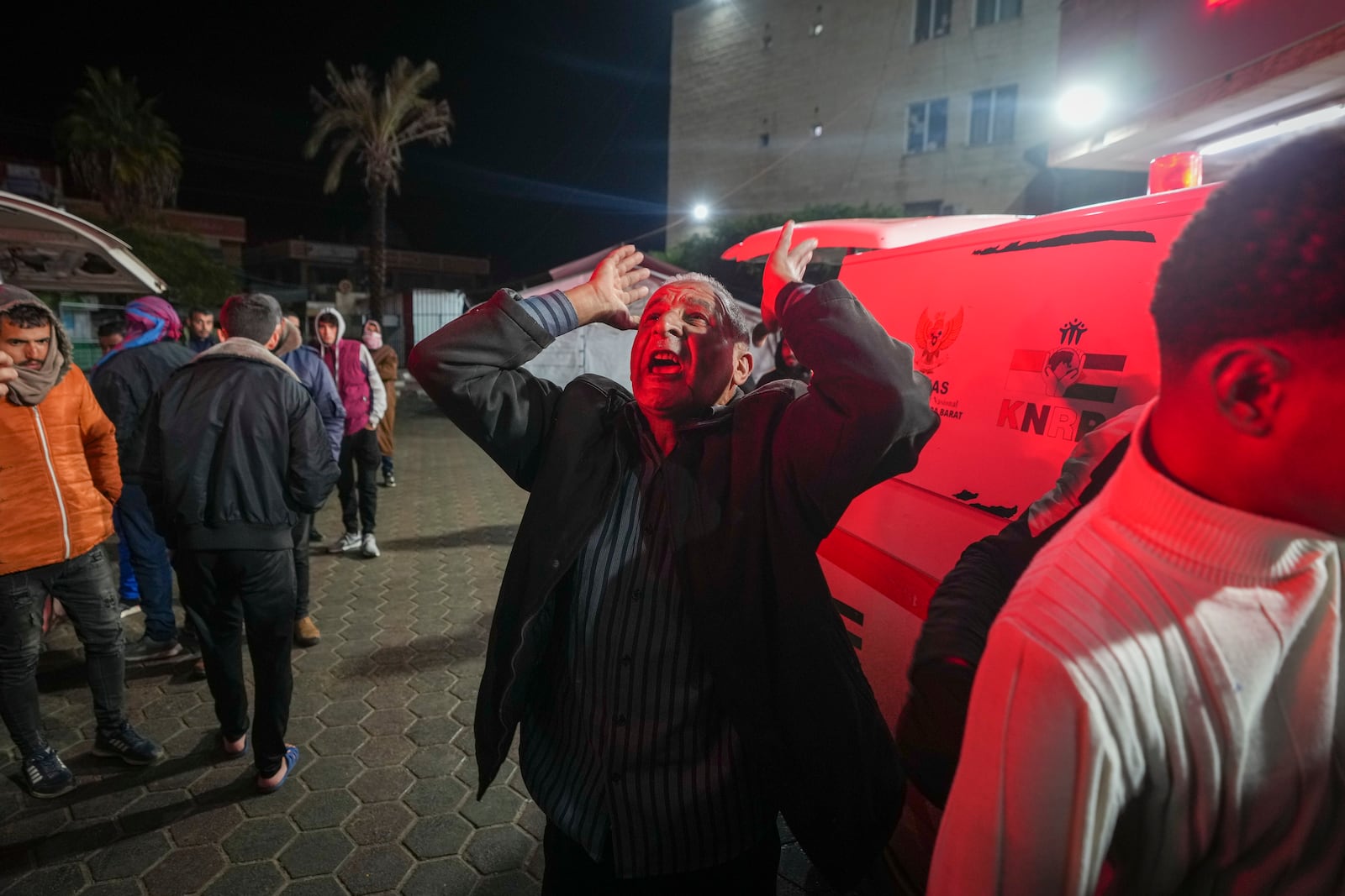 A man reacts in grief as the body of 8-year-old Adam Farajallah is brought to Al-Aqsa Martyrs Hospital following an airstrike on a house in the Bureij refugee camp, in the central Gaza Strip town of Deir al-Balah Wednesday, Jan. 1, 2025. (AP Photo/Abdel Kareem Hana)