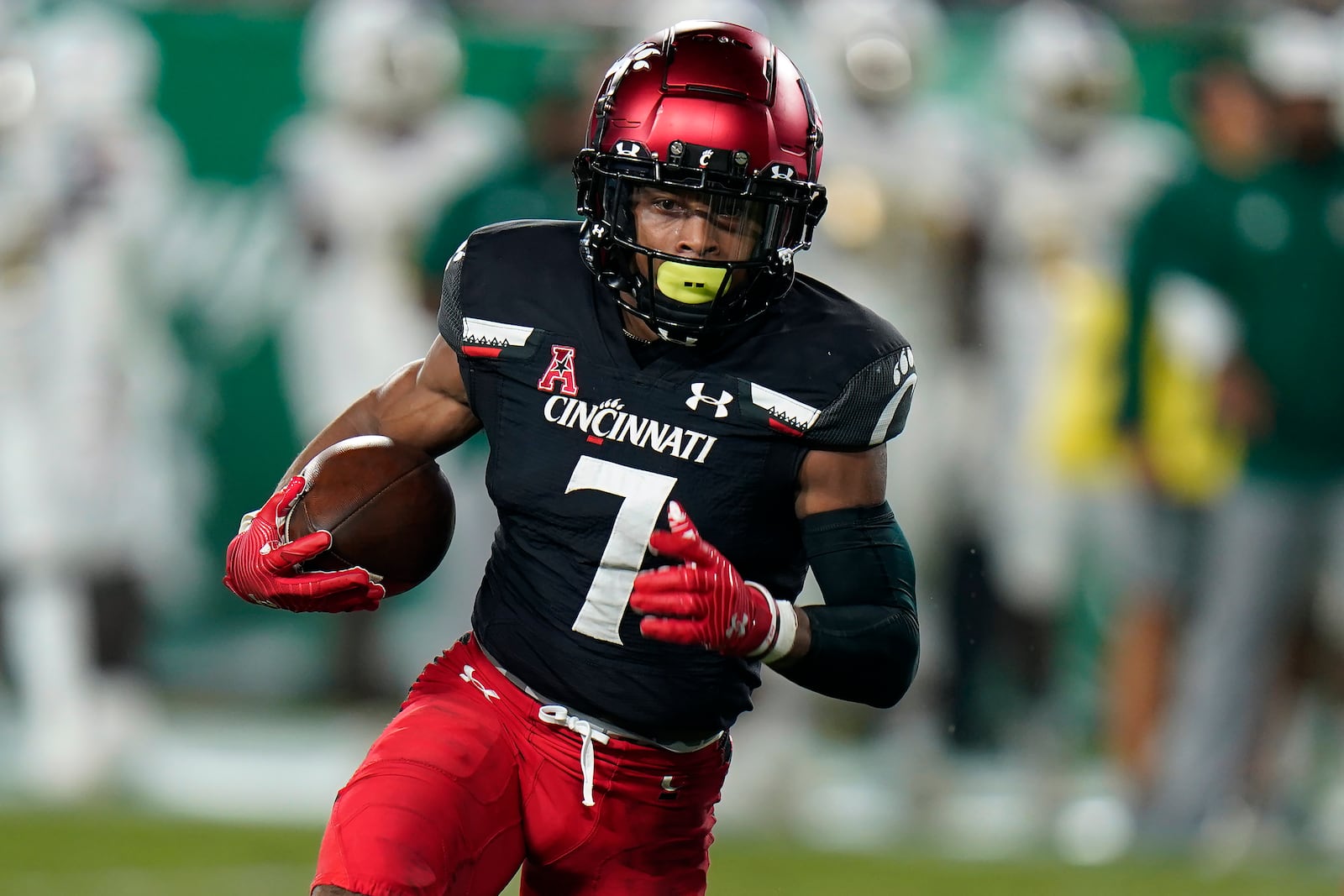 Cincinnati wide receiver Tre Tucker runs for a score on a 1-yard touchdown pass quarterback Desmond Ridder against South Florida during the first half of an NCAA college football game Friday, Nov. 12, 2021, in Tampa, Fla. (AP Photo/Chris O'Meara)