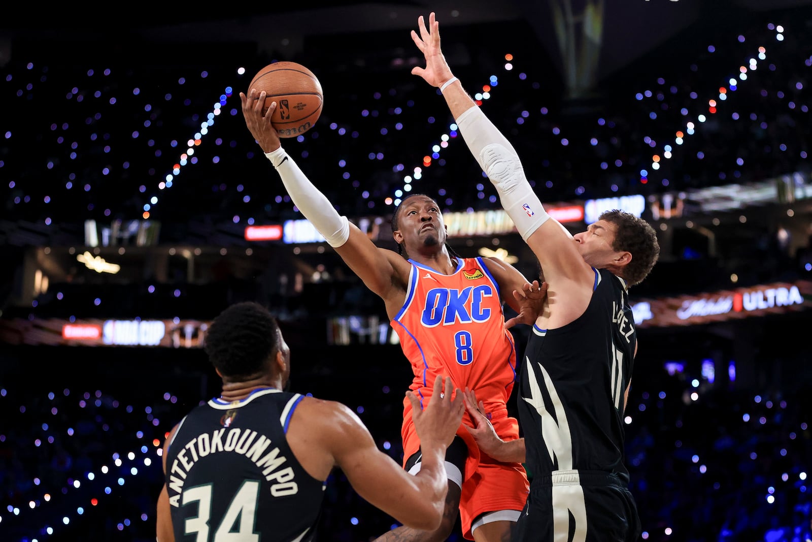 Oklahoma City Thunder forward Jalen Williams (8) shoots against Milwaukee Bucks forward Giannis Antetokounmpo (34) and center Brook Lopez (11) during the first half of the championship game in the NBA Cup basketball tournament Tuesday, Dec. 17, 2024, in Las Vegas. (AP Photo/Ian Maule)