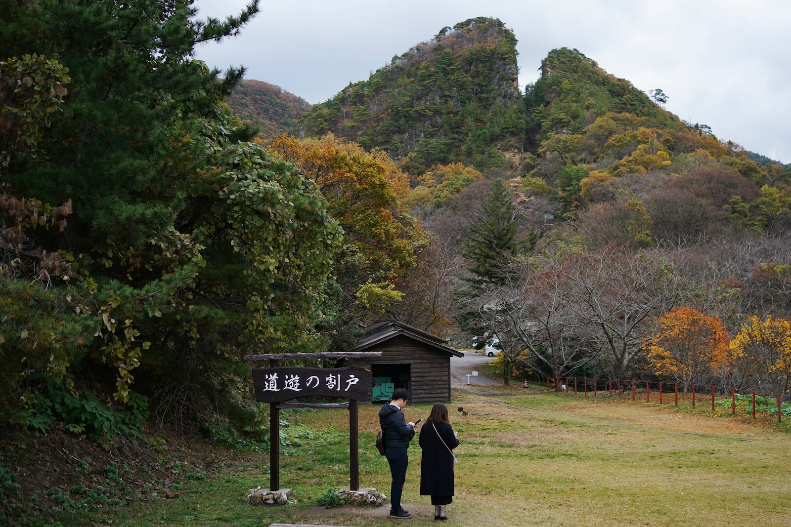 Visitors stand near Doyu no Warito, symbolic remain of the Sado Gold Mine, in Sado, Niigata prefecture, Japan, Sunday, Nov. 24, 2024. (AP Photo/Eugene Hoshiko)