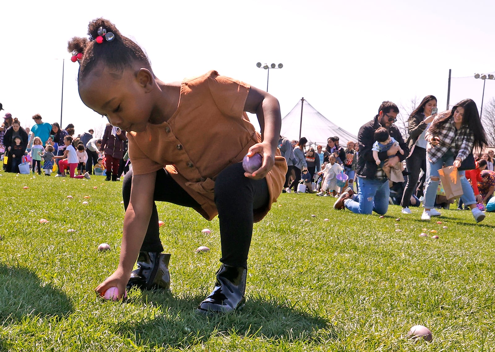 Sunshine and warm weather brought hundreds of children out to participate in the 40th Annual Easter Egg Hunt at Young's Jersey Dairy Sunday, April 9, 2023. Young's put out 11,000 hard boiled and colored eggs on their driving range this year. The childred rushed across the grassy field in three age groups picking up the thousands of eggs in a matter of minutes. Dan Young, owner of the dairy, said it was a lot different than when they started 40 years ago with a couple hundred eggs. BILL LACKEY/STAFF