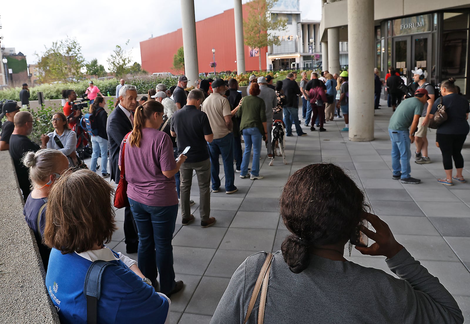 People wait outside the Springfield City Hall Forum as they wait to be let in for the City Commission meeting Tuesday, Sept. 24, 2024. BILL LACKEY/STAFF