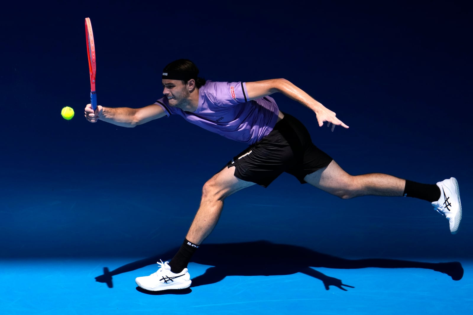 Taylor Fritz of the U.S. plays a forehand return to Jenson Brooksby of the U.S. during their first round match at the Australian Open tennis championship in Melbourne, Australia, Tuesday, Jan. 14, 2025. (AP Photo/Vincent Thian)