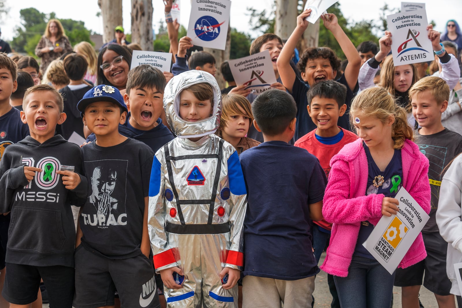 Students at Santiago STEAM Magnet Elementary School participate at a ceremony to plant a small Giant Sequoia tree from NASA's Artemis I Mission's tree seeds that traveled around the moon twice, after the school was honored in the spring of 2024 to become NASA Moon Tree Stewards in Lake Forest, Calif., on Monday, Oct. 14, 2024. (AP Photo/Damian Dovarganes)