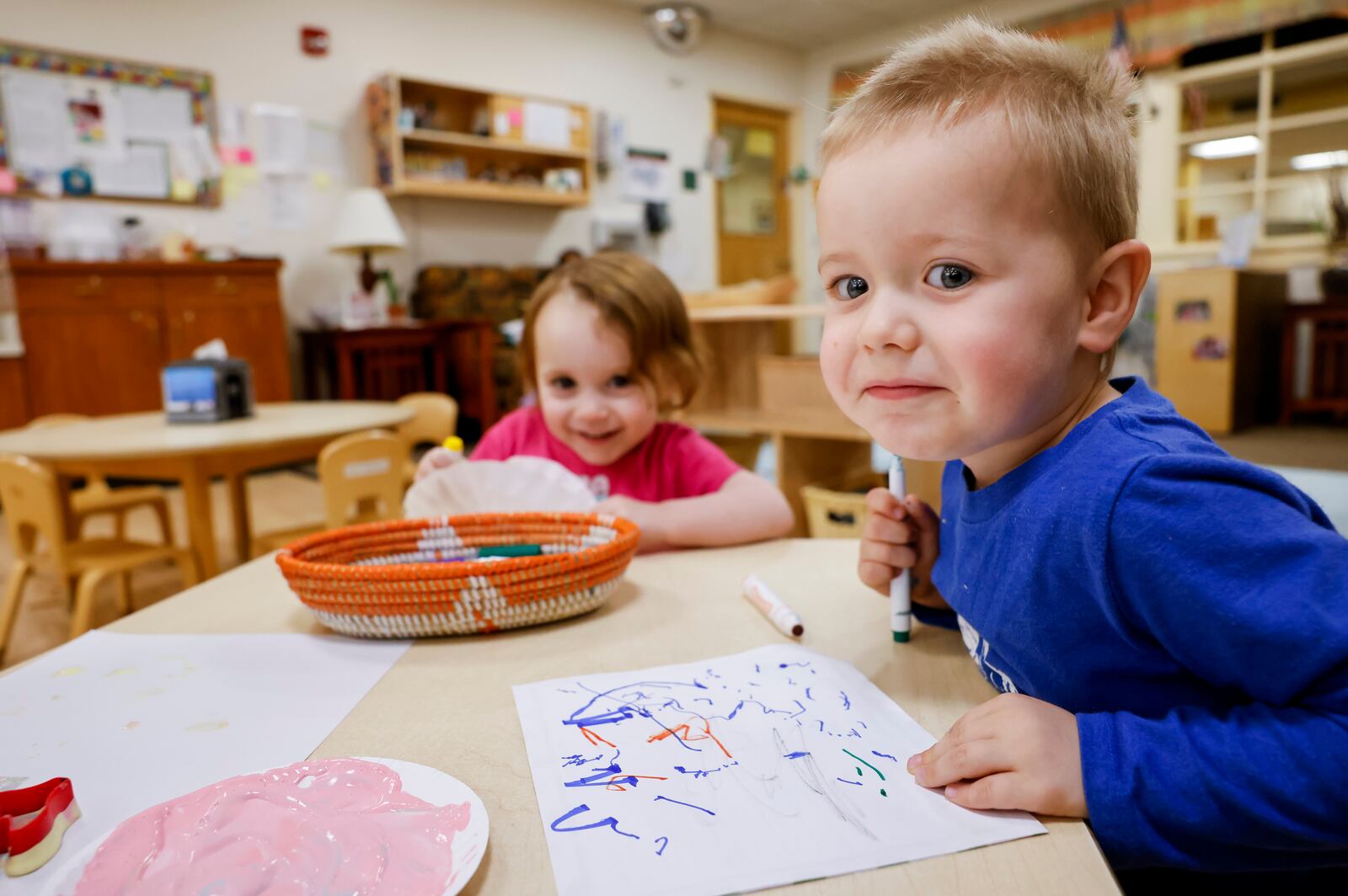 McKenna C. and Emily A., students in the toddler class at Mini University, a child development center on the Miami University campus, color on paper Thursday, April 6, 2023 in Oxford. NICK GRAHAM/STAFF