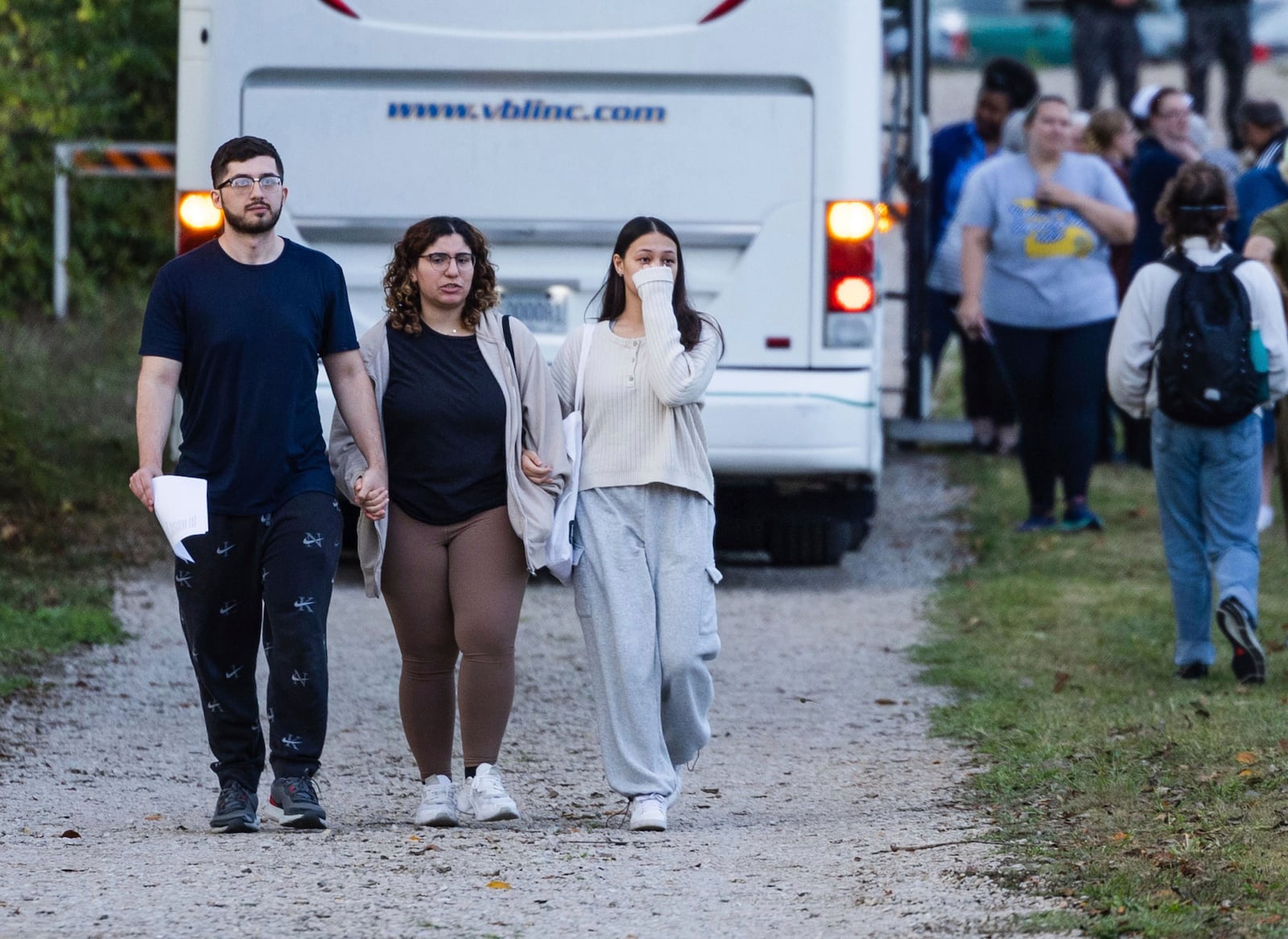 Summer Hishmeh, center, and Sakura Hassan, both from St. Louis, hold hands and cry as they walk with another man away from a protest against the execution of Marcellus Williams outside of the Missouri Department of Corrections prison, Tuesday, Sept. 24, 2024, in Bonne Terre, Mo. (Zachary Linhares/St. Louis Post-Dispatch via AP)