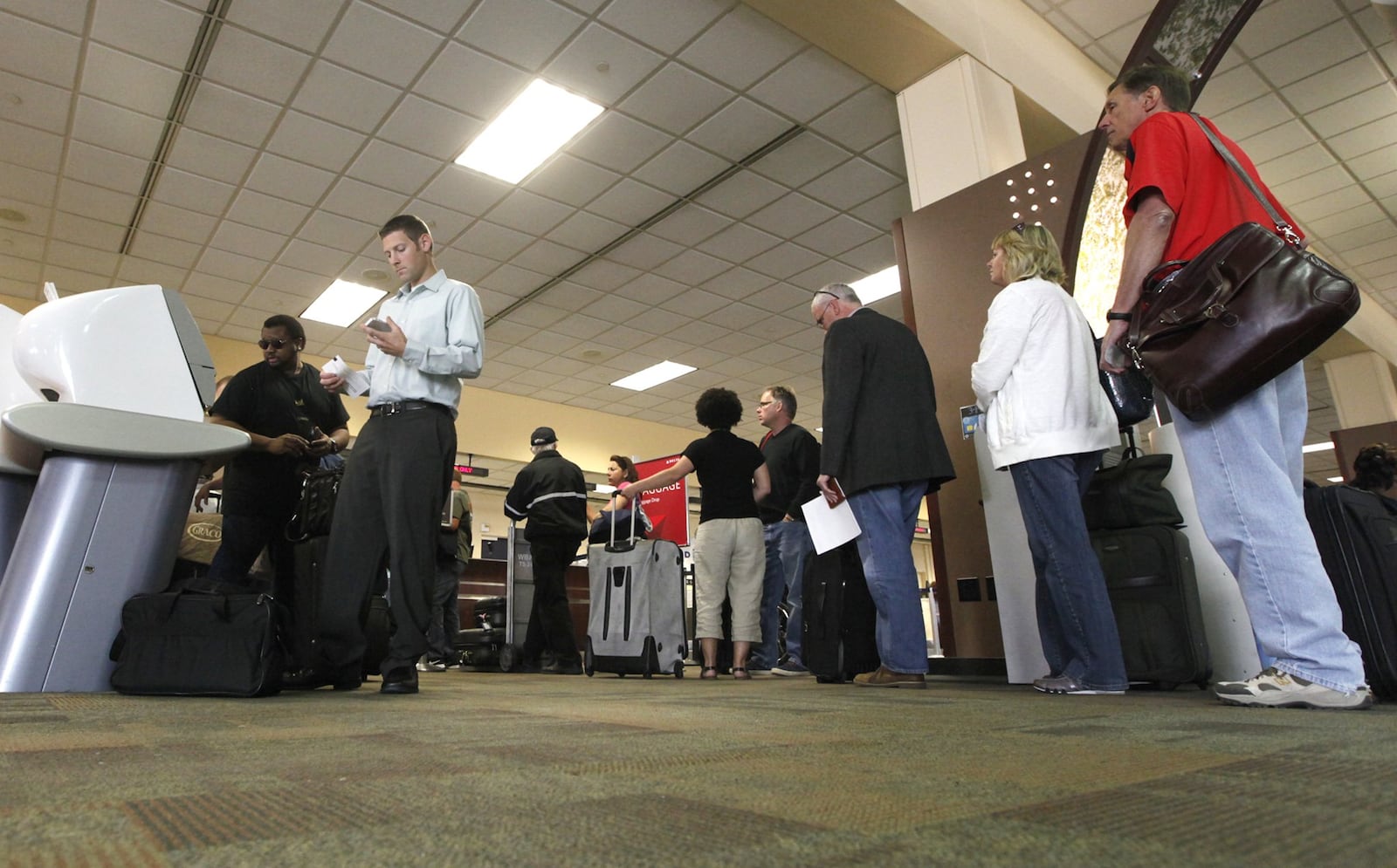 Passengers at the Dayton International Airport check in for departing flights on Tuesday, September 24. Airfares will start rising in about three weeks in advance of the holiday travel season, according to a report released Tuesday. An analysis of last year’s air fares by the comparison travel website Kayak found that average prices for domestic travel for Thanksgiving jumped 17 percent above the lowest average fares after mid-October. For Christmas and New Year’s Eve, average fares increased up to 51 percent and 25 percent, respectively, after mid-October. TY GREENLEES / STAFF