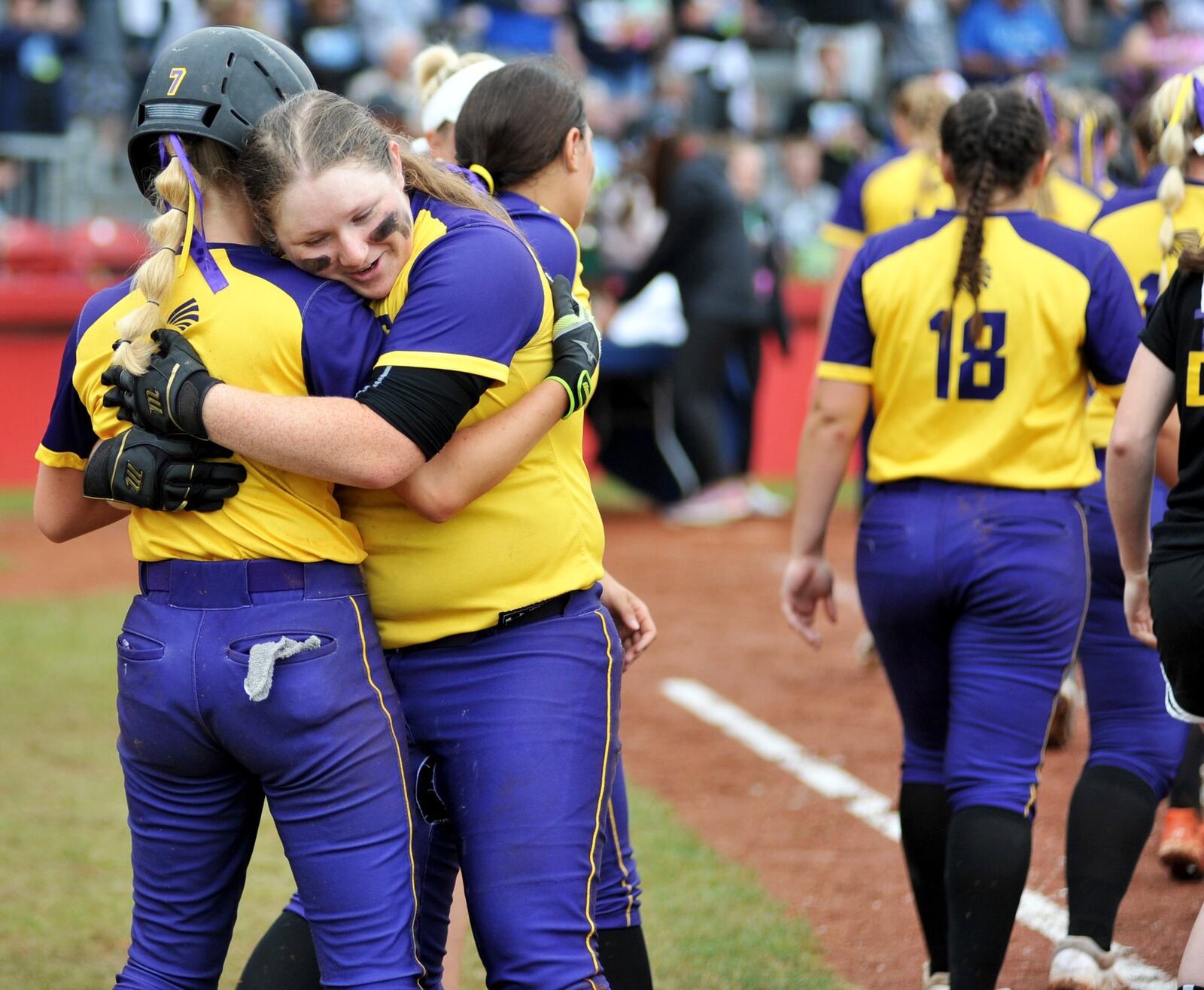 Mechanicsburg’s Megan Alspaugh (21) hugs teammate Audrey Ayars (7) on Sunday after the Indians lost to Antwerp 5-0 in the Division IV state championship softball game at Firestone Stadium in Akron. RICK CASSANO/STAFF