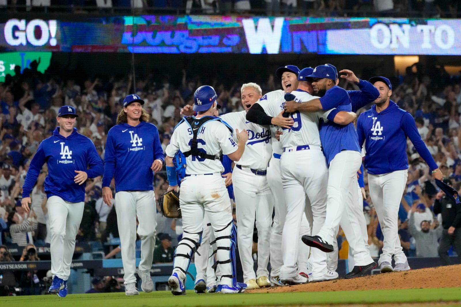 The Los Angeles Dodgers celebrate off the mound after defeating the San Diego Padres in Game 5 of a baseball NL Division Series Friday, Oct. 11, 2024, in Los Angeles. (AP Photo/Mark J. Terrill)