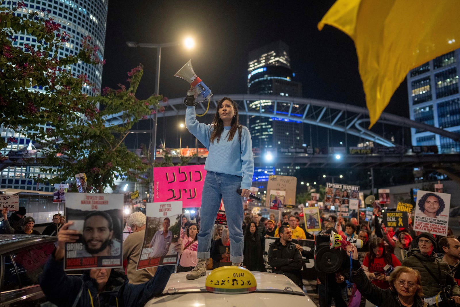 Israelis protest against Prime Minister Benjamin Netanyahu's government and call for the release of hostages held in the Gaza Strip by the Hamas militant group, in Tel Aviv, Israel, Monday, Jan. 6, 2025. (AP Photo/Ohad Zwigenberg)