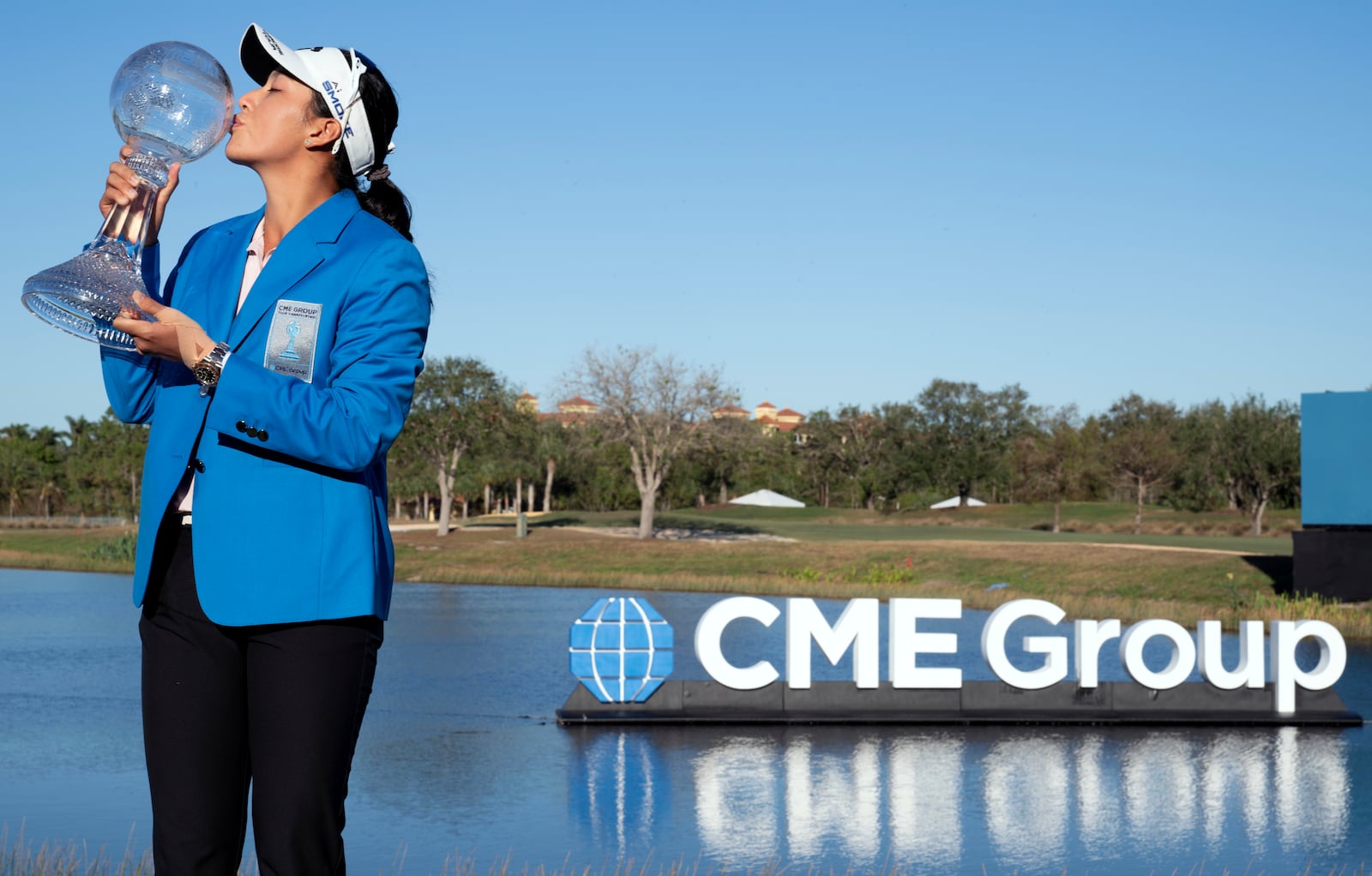 Jeeno Thitikul stands on the 18th green and kisses the LPGA CME Group Tour Championship golf tournament trophy Sunday, Nov. 24, 2024, in Naples, Fla. (AP Photo/Chris Tilley)