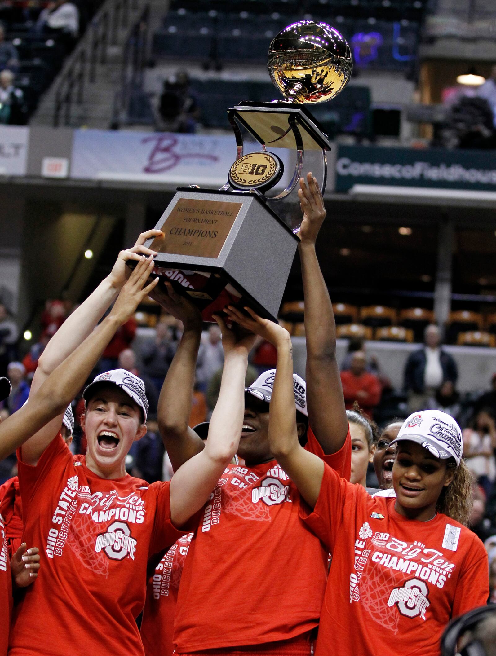 Ohio State's Sarah Schulze, left, Jantel Lavender, and Brittany Johnson, right, hold the championship trophy after Ohio State defeated Penn State 84-70 in an NCAA college basketball game, winning the Big Ten tournament in Indianapolis, Sunday, March 6, 2011. (AP Photo/Michael Conroy)