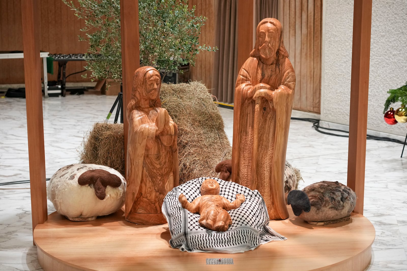 A view of Nativity Scene, crafted in the West Bank city of Bethlehem, with Baby Jesus' crib covered by a Palestinian kaffiyeh donated by delegates of the Palestinian Embassy to the Holy See, in the Pope Paul VI hall at the Vatican, Saturday, Dec. 7, 2024. (AP Photo/Andrew Medichini)