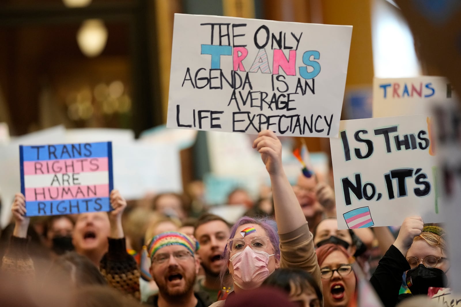 Protesters fill the Iowa state Capitol to denounce a bill that would strip the state civil rights code of protections based on gender identity, Thursday, Feb. 27, 2025, in Des Moines, Iowa. (AP Photo/Charlie Neibergall)