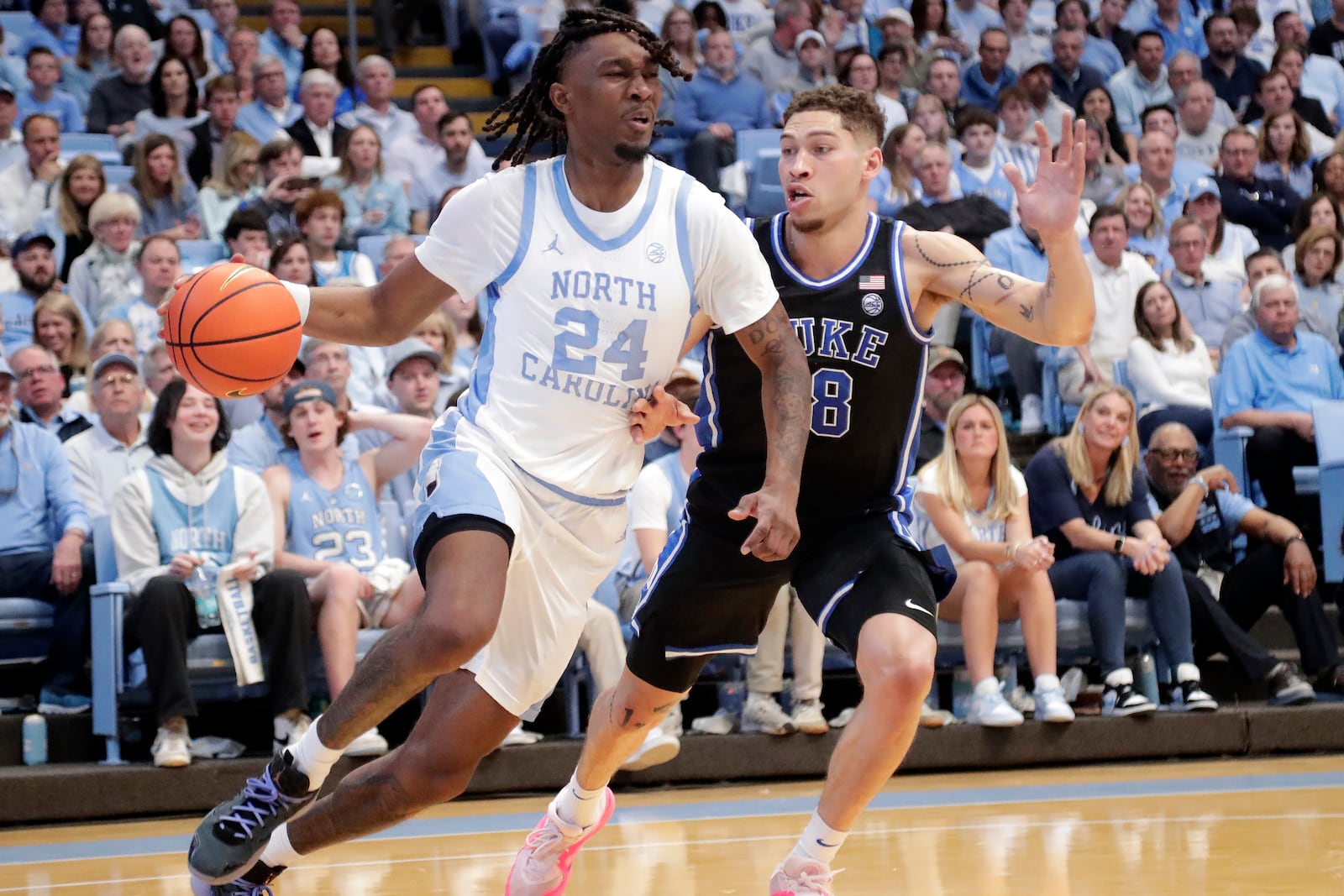 North Carolina forward Jae'Lyn Withers (24) drives against Duke forward Mason Gillis (18) during the first half of an NCAA college basketball game Saturday, March 8, 2025, in Chapel Hill, N.C. (AP Photo/Chris Seward)