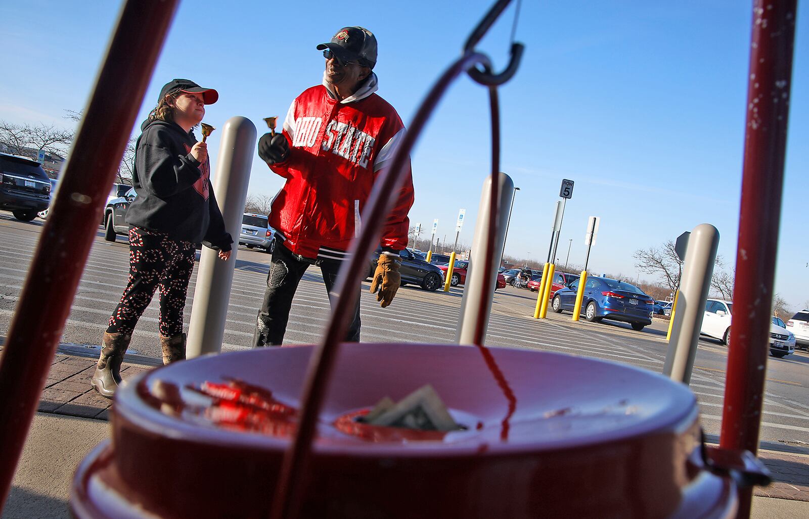 Sarah Snyder, 10, rings the Salvation Army bell with  Steven Hunter, Thursday, Dec. 7, 2023 as she helps ring the bell outside the Walmart on Bechtle Avenue. Sarah made friends with Steven when she lived in Springfield a few years ago and now returns every year from Montana to see him and ring the bell for the Salvation Army.  Sarah raises the money for the trip and this year donated $800 which she raised by making and selling craft items throughout the year. BILL LACKEY/STAFF