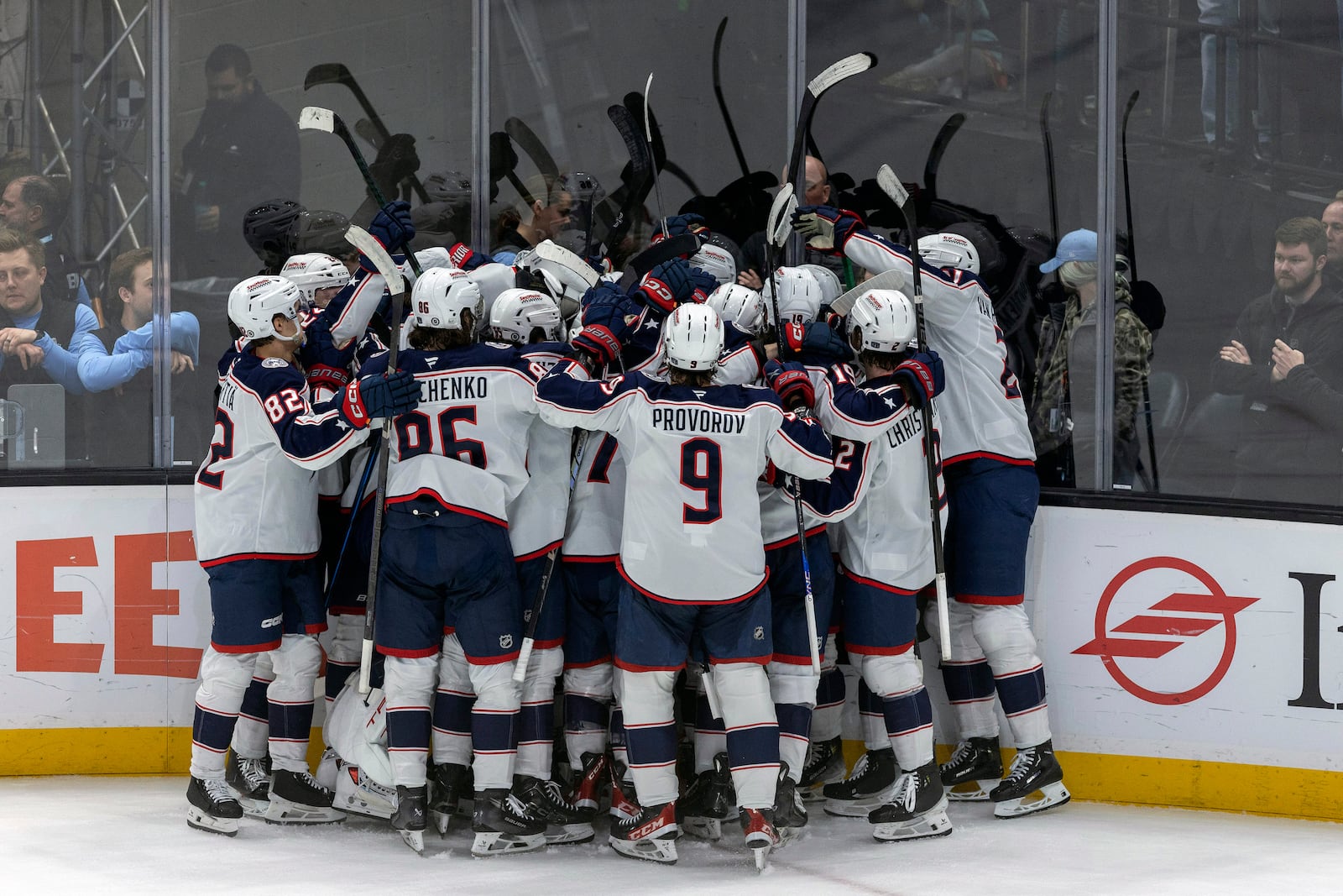 Columbus Blue Jackets players celebrate after a goal by right wing Justin Danforth (obscured) against the Utah Hockey Club in overtime of an NHL hockey game Friday, Jan. 31, 2025, in Salt Lake City. (AP Photo/Melissa Majchrzak)