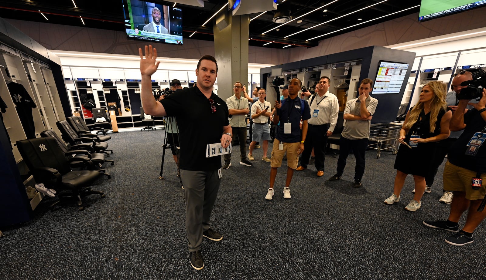 New York Yankees director of baseball operations Matthew Ferry, left, talks with the media in the newly completed Yankees clubhouse during a tour of the upgraded team spring training facilities Thursday, Feb 13, 2025, at George M. Steinbrenner Field in Tampa, Fla. (AP Photo/Steve Nesius)