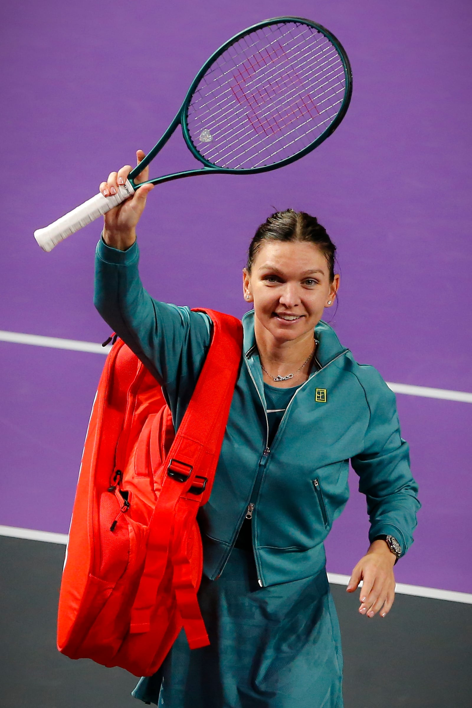 Romania's Simona Halep waves to fans after announcing her retirement from professional tennis following a defeat at the Transylvania Open women's tennis tournament, Tuesday, Feb. 4, 2025, in Cluj, Romania. (Mihaela-Ionela Bobar/Action Foto Romania via AP)