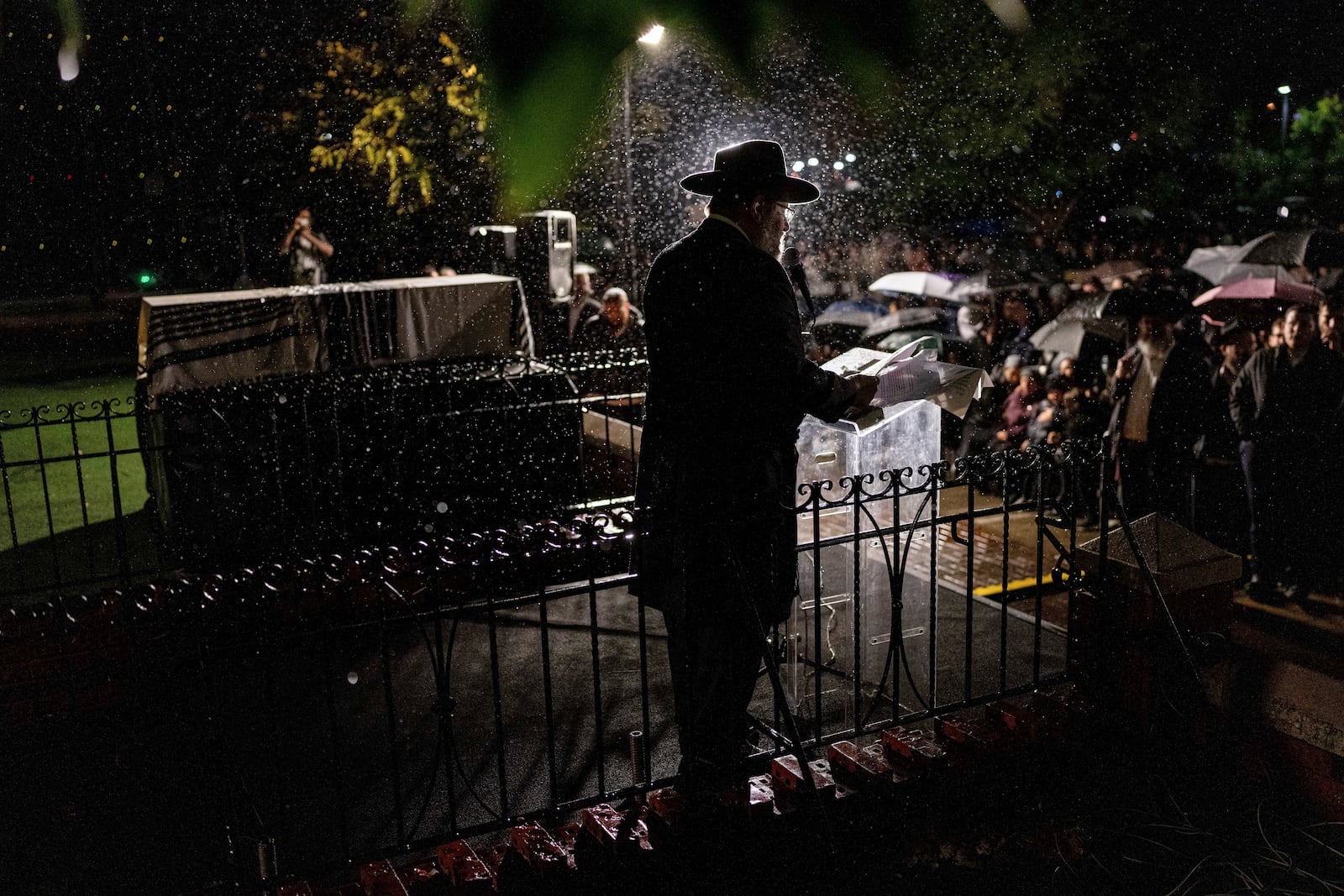 A rabbi delivers an eulogy next to the coffin containing the remains of Israeli-Moldovan rabbi Zvi Kogan in Kfar Chabad, Israel, Monday Nov. 25, 2024. Kogan, 28, an ultra-Orthodox rabbi, was killed last week in Dubai where he ran a kosher grocery store. Israelis have flocked for commerce and tourism since the two countries forged diplomatic ties in the 2020 Abraham Accords.(AP Photo/Ohad Zwigenberg)