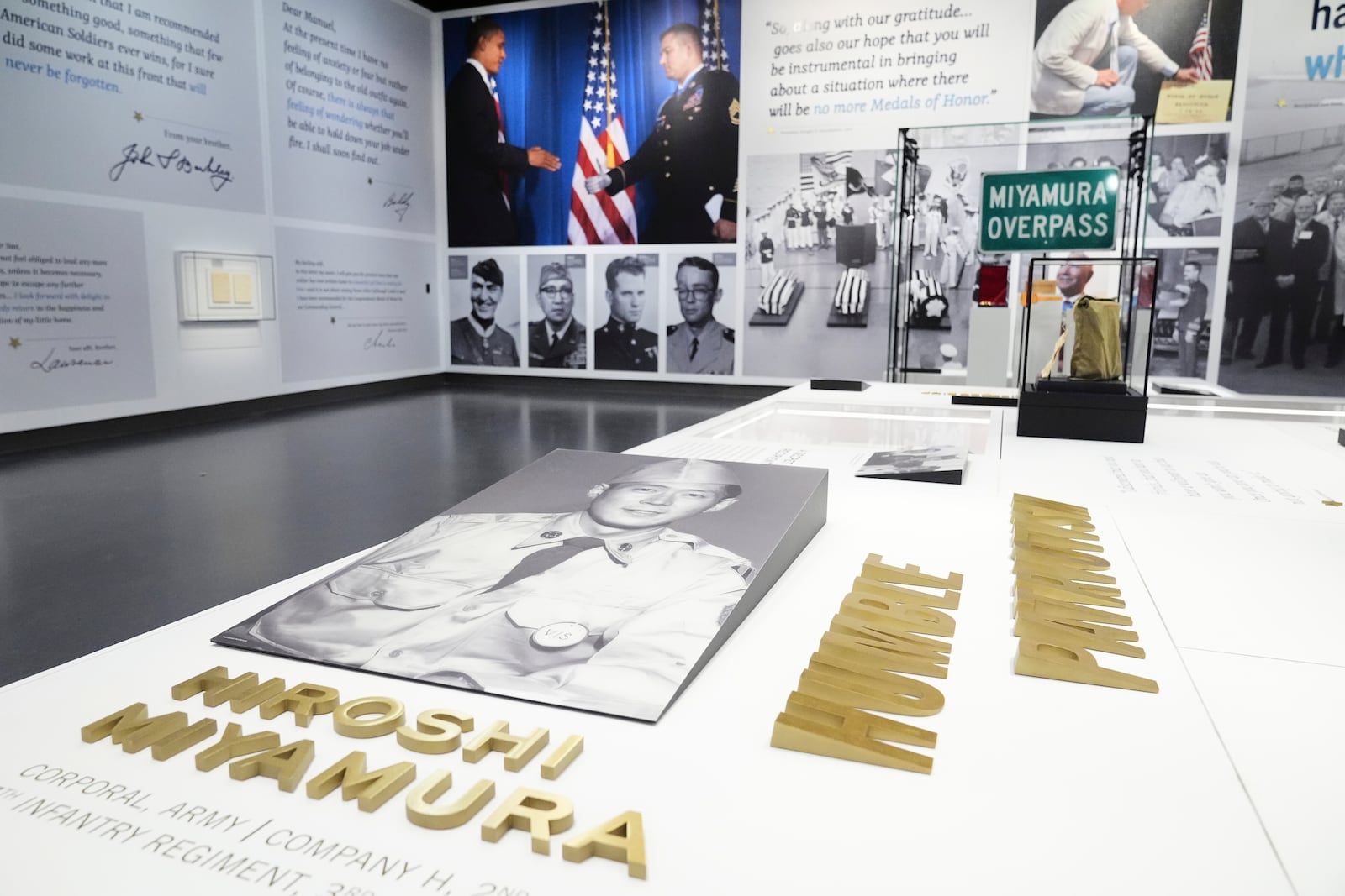 An image of World War II medal of honor recipient Hiroshi Miyamura, front, sits on display by artifacts of several other MOH recipients at the National Medal of Honor Museum in Arlington, Texas, Thursday, March 13, 2025. (AP Photo/Tony Gutierrez)