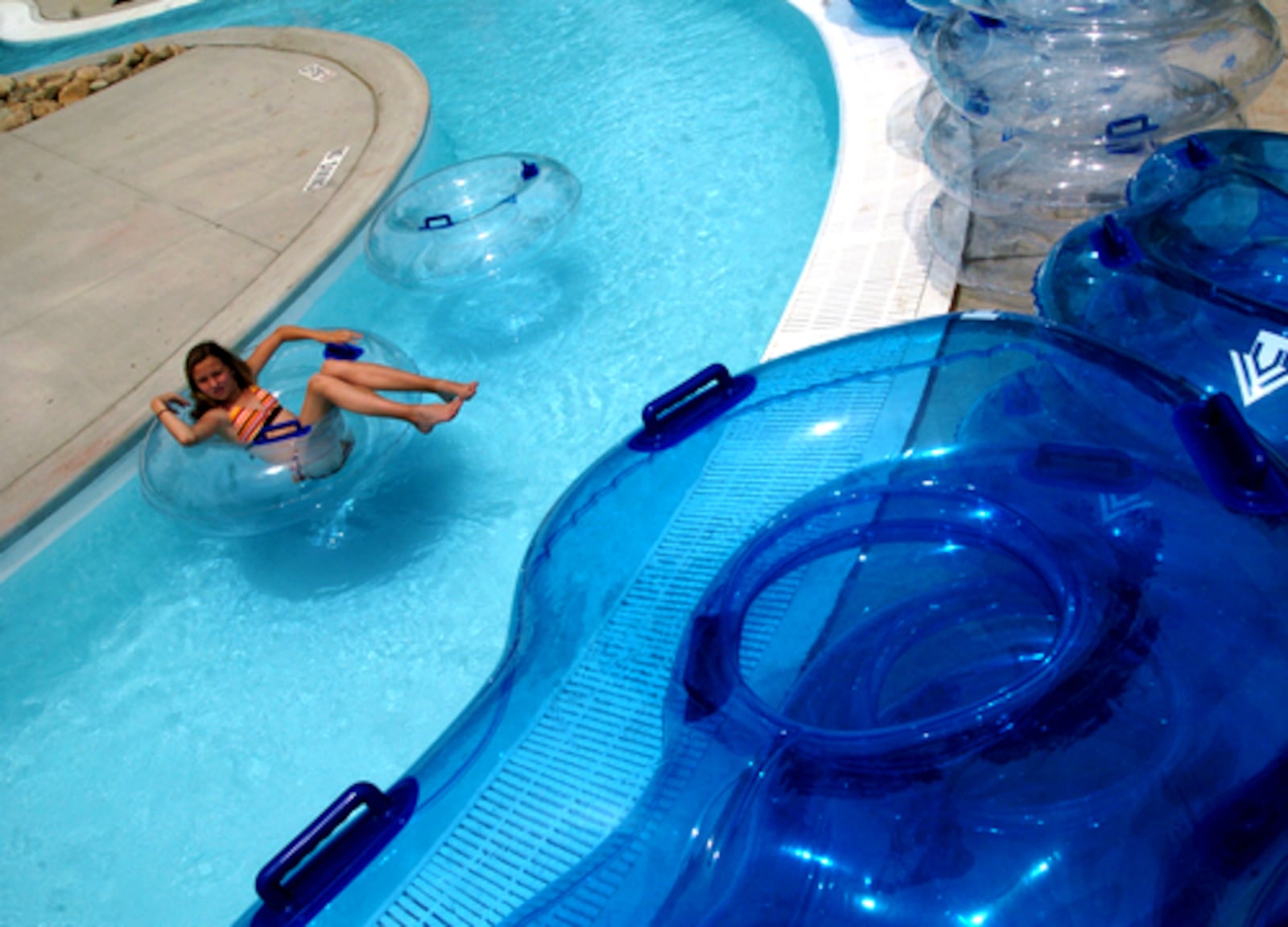 Ashton Gerard, 12, relaxes in a raft as she slowly floats down the "Lazy River" portion of the Splash Zone pool Saturday.