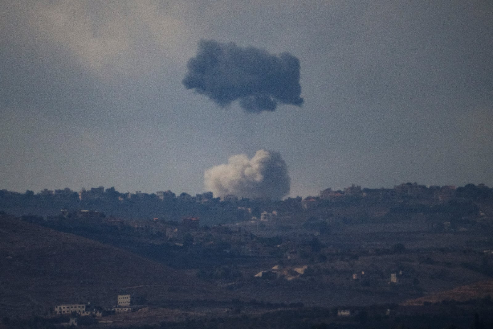 Smokes rise following an explosion in southern Lebanon as seen from northern Israel, Thursday, Oct. 17, 2024. (AP Photo/Leo Correa)