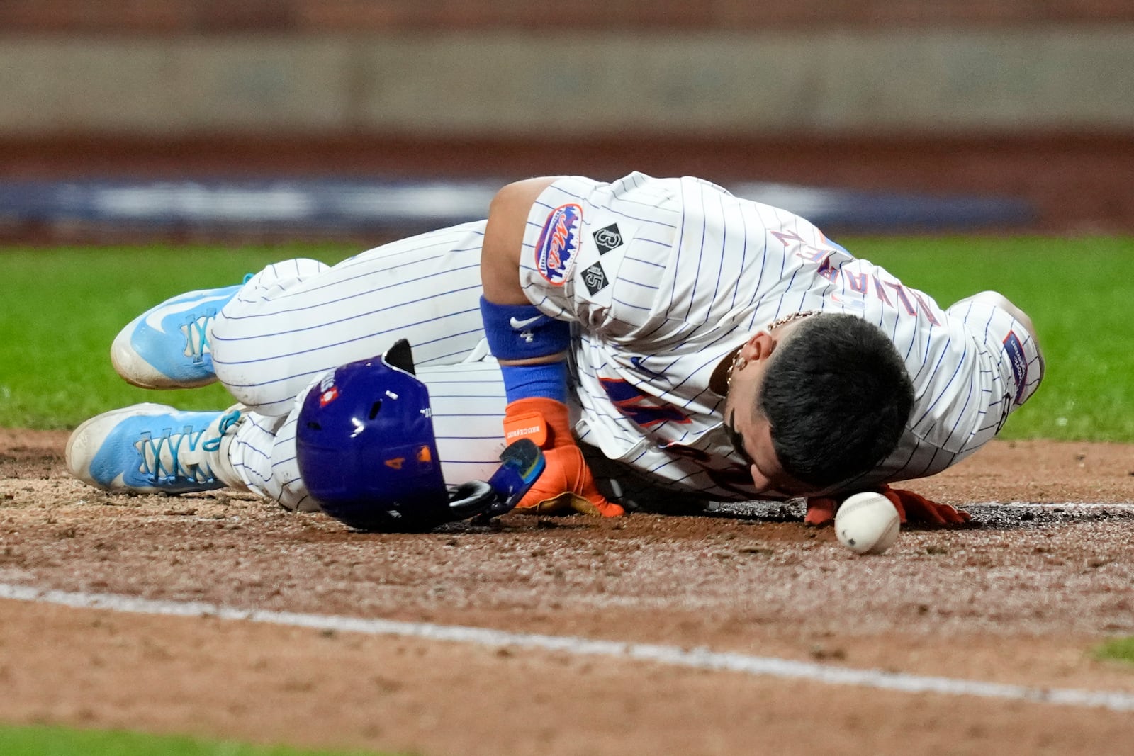 New York Mets' Francisco Alvarez gets hit by pitch against the Los Angeles Dodgers during the fifth inning in Game 4 of a baseball NL Championship Series, Thursday, Oct. 17, 2024, in New York. (AP Photo/Ashley Landis)