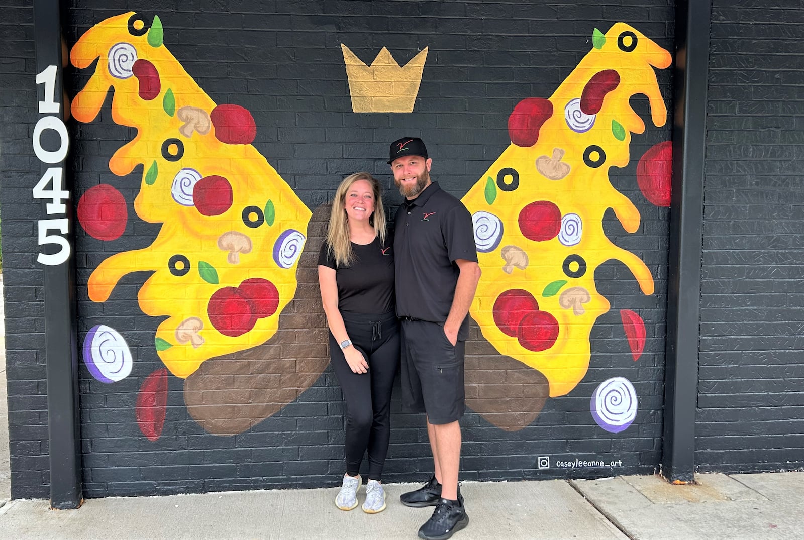 Owners Ashley and Mike Estep pose in front of a mural at their restaurant The Villa Pizzeria on Friday, Sept. 2, 2023. JESSICA OROZCO/STAFF