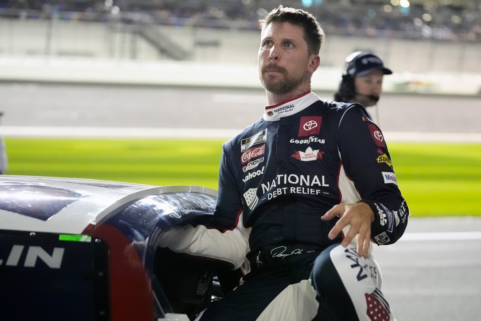 Denny Hamlin climbs out of his car after qualifying for the NASCAR Daytona 500 auto race at Daytona International Speedway, Wednesday, Feb. 12, 2025, in Daytona Beach, Fla. (AP Photo/John Raoux)