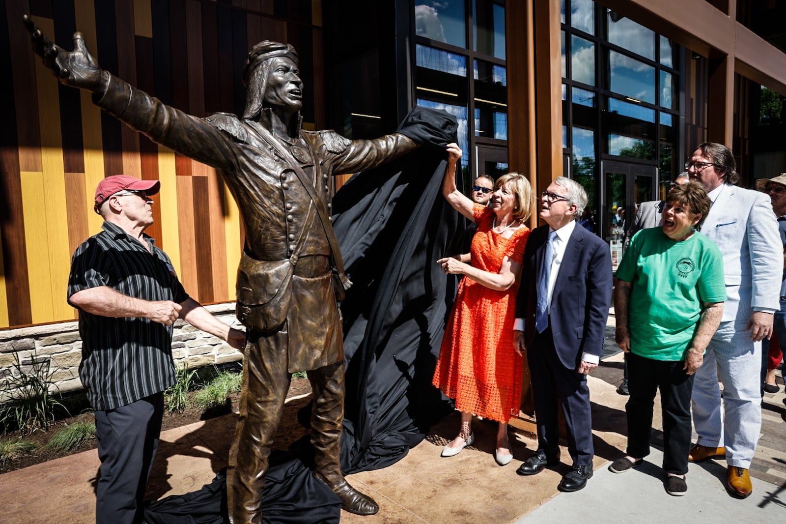 Sculptor Alan Cottrill, left, unveils a bronze of Shawnee leader Tecumseh at the ribbon cutting ceremony of the Great Council State Park Friday morning June 7, 2024. JIM NOELKER/STAFF