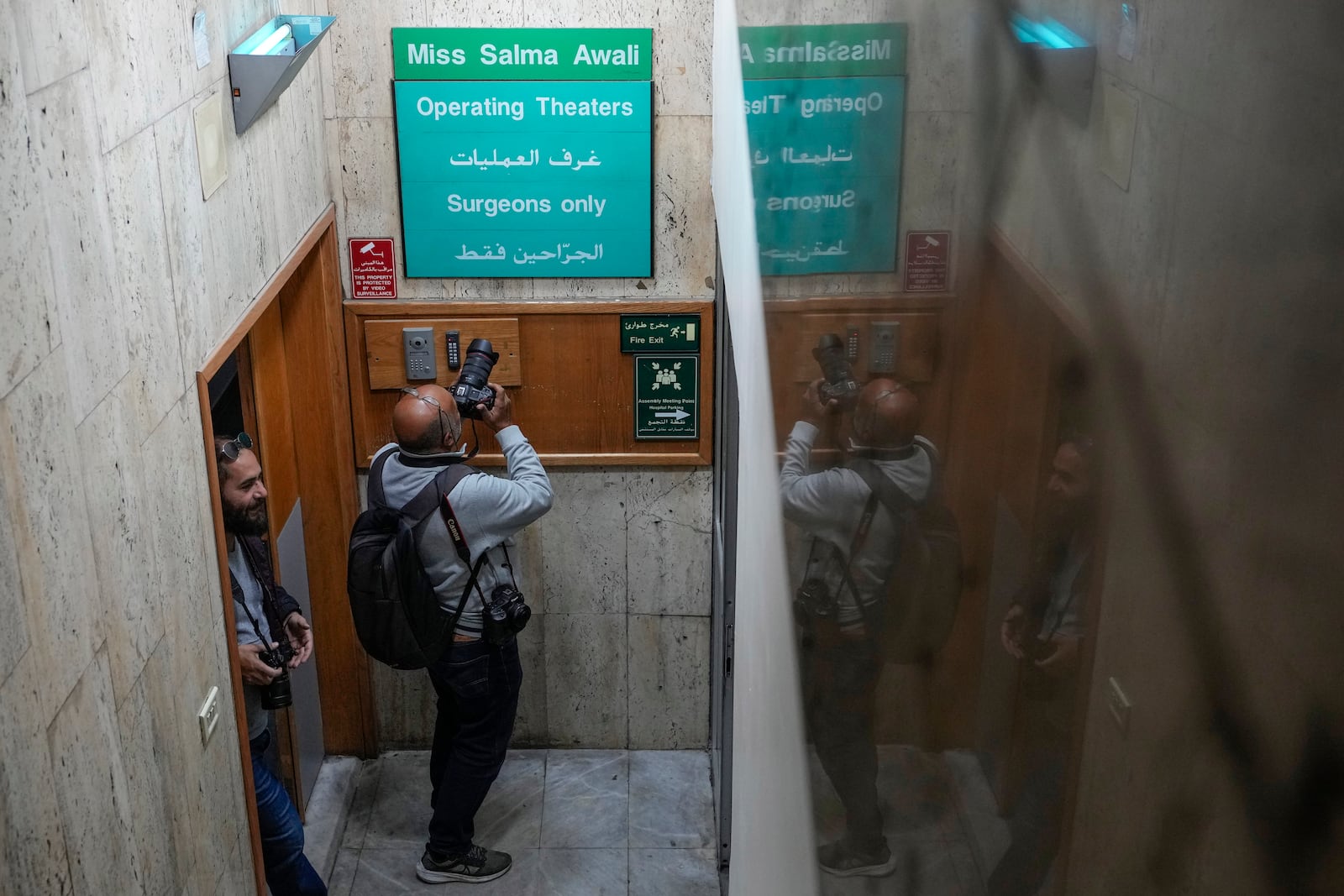 Journalists take a tour inside Sahel General Hospital, in Dahiyeh, Beirut, Lebanon, Tuesday, Oct. 22, 2024, a day after the Israeli army said that Hezbollah is storing hundreds of millions of dollars in cash and gold under the hospital. (AP Photo/Hassan Ammar)