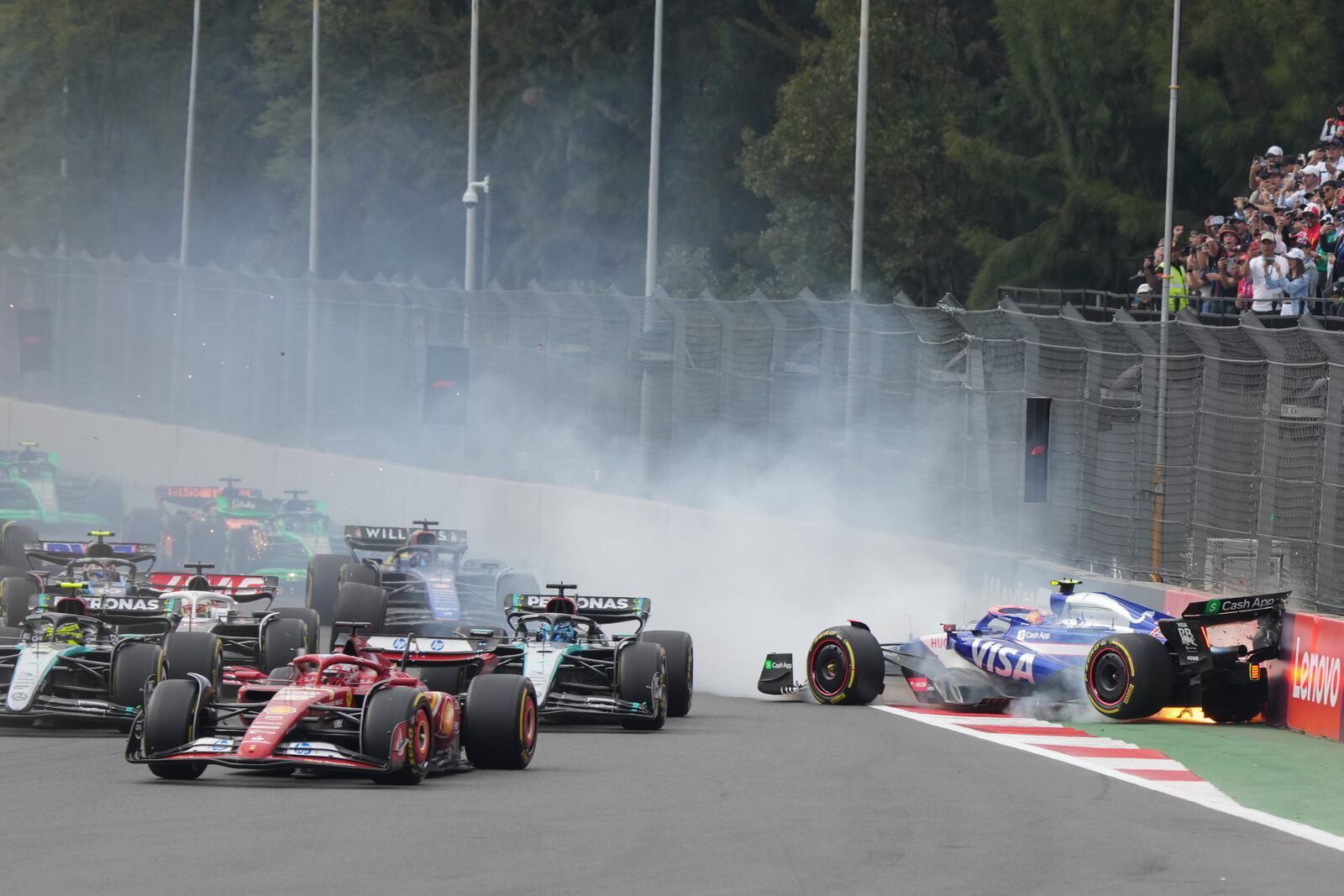 RB driver Yuki Tsunoda of Japan crashes after the start of the Formula One Mexico Grand Prix auto race at the Hermanos Rodriguez racetrack in Mexico City, Sunday, Oct. 27, 2024. (AP Photo/Fernando Llano)