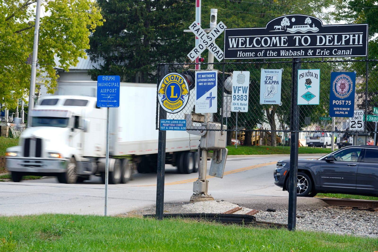 A semi-truck crosses a railroad crossing on the edge of town in Delphi, Ind., Tuesday, Oct. 1, 2024. (AP Photo/Michael Conroy)