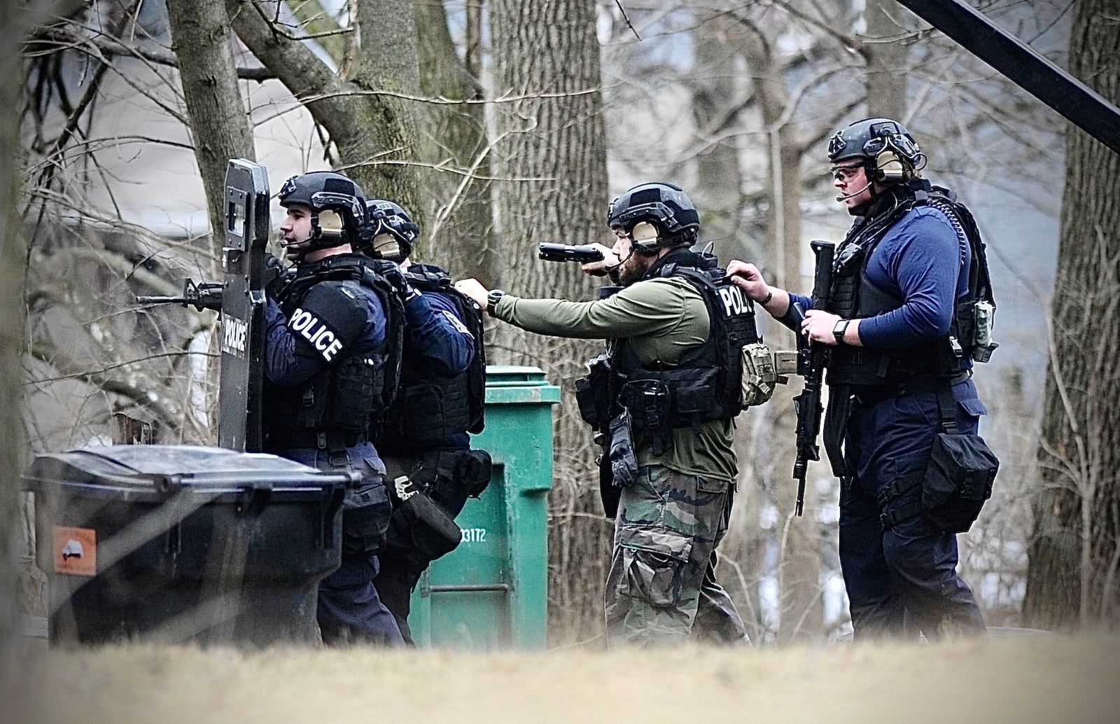 Members of the Springfield Police Division's Special Response Team prepared to enter a house on South Race Street looking for a shooting suspect Monday, Jan. 2, 2023. MARSHALL GORBY \STAFF