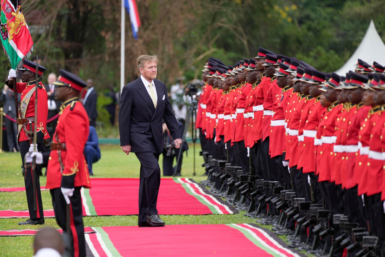 King Willem-Alexander of the Netherlands reviews an honor guard after arriving to meet with Kenya's President William Ruto at State House in Nairobi, Kenya, Tuesday, March 18, 2025. (AP Photo/Brian Inganga)