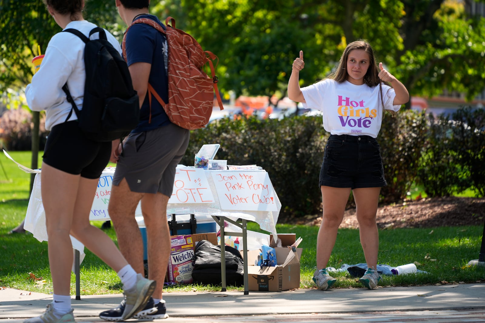 Marisa Myers, right, encourages passing University of Pittsburgh students to register to vote on campus in Pittsburgh, Thursday, Sept. 12, 2024. (AP Photo/Gene J. Puskar)