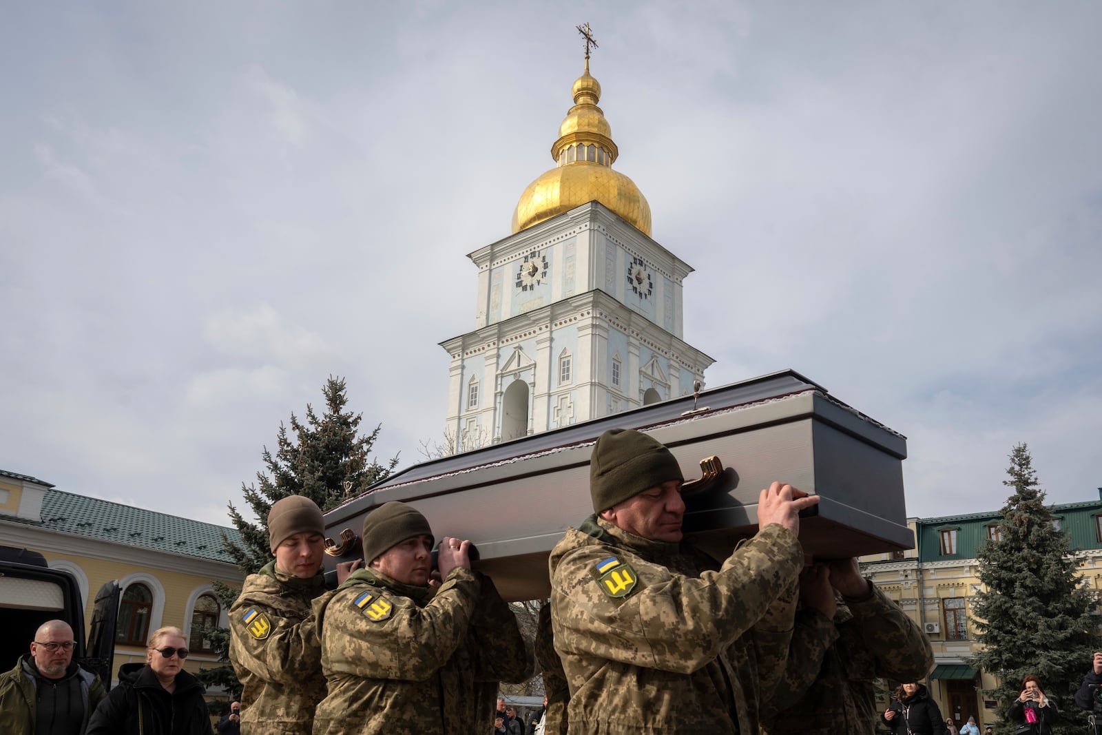 Servicemen carry the coffin of Ukrainian soldier Vasyl Ratushnyy, 28, during the funeral ceremony in St. Michael Cathedral in Kyiv, Ukraine, Wednesday, March 5, 2025. (AP Photo/Efrem Lukatsky)