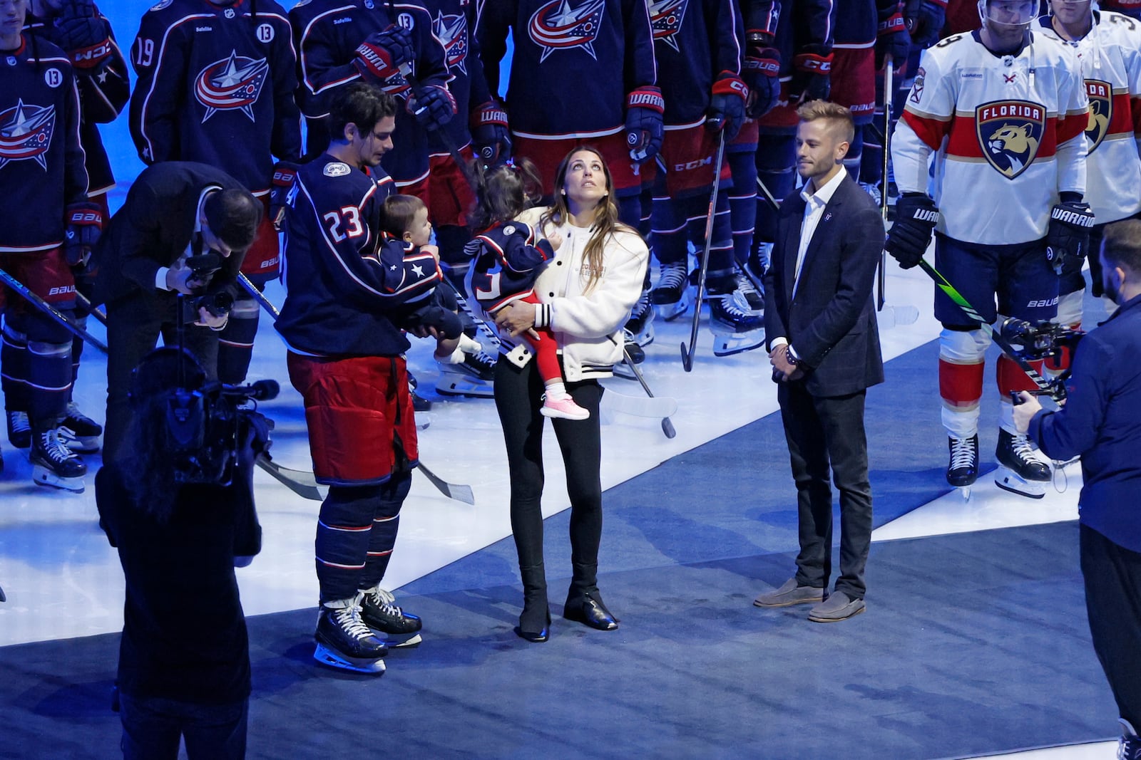 Blue Jackets' Johnny Gadreau's family watches a #13 banner being raised during a ceremony before the start of an NHL hockey game between the Columbus Blue Jackets and the Florida Panthers. Tuesday, Oct. 15, 2024, in Columbus, Ohio. (AP Photo/Jay LaPrete)