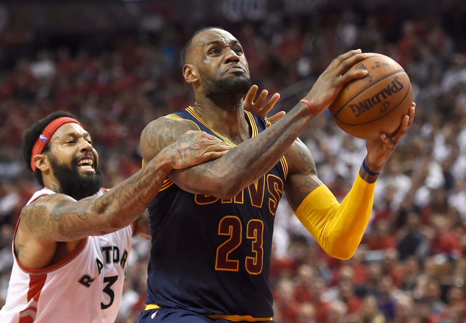 FILE - Toronto Raptors forward James Johnson fouls Cleveland Cavaliers forward LeBron James late in the fourth quarter of Game 6 of the NBA basketball Eastern Conference finals, on May 27, 2016, in Toronto. (Frank Gunn/The Canadian Press via AP, File)