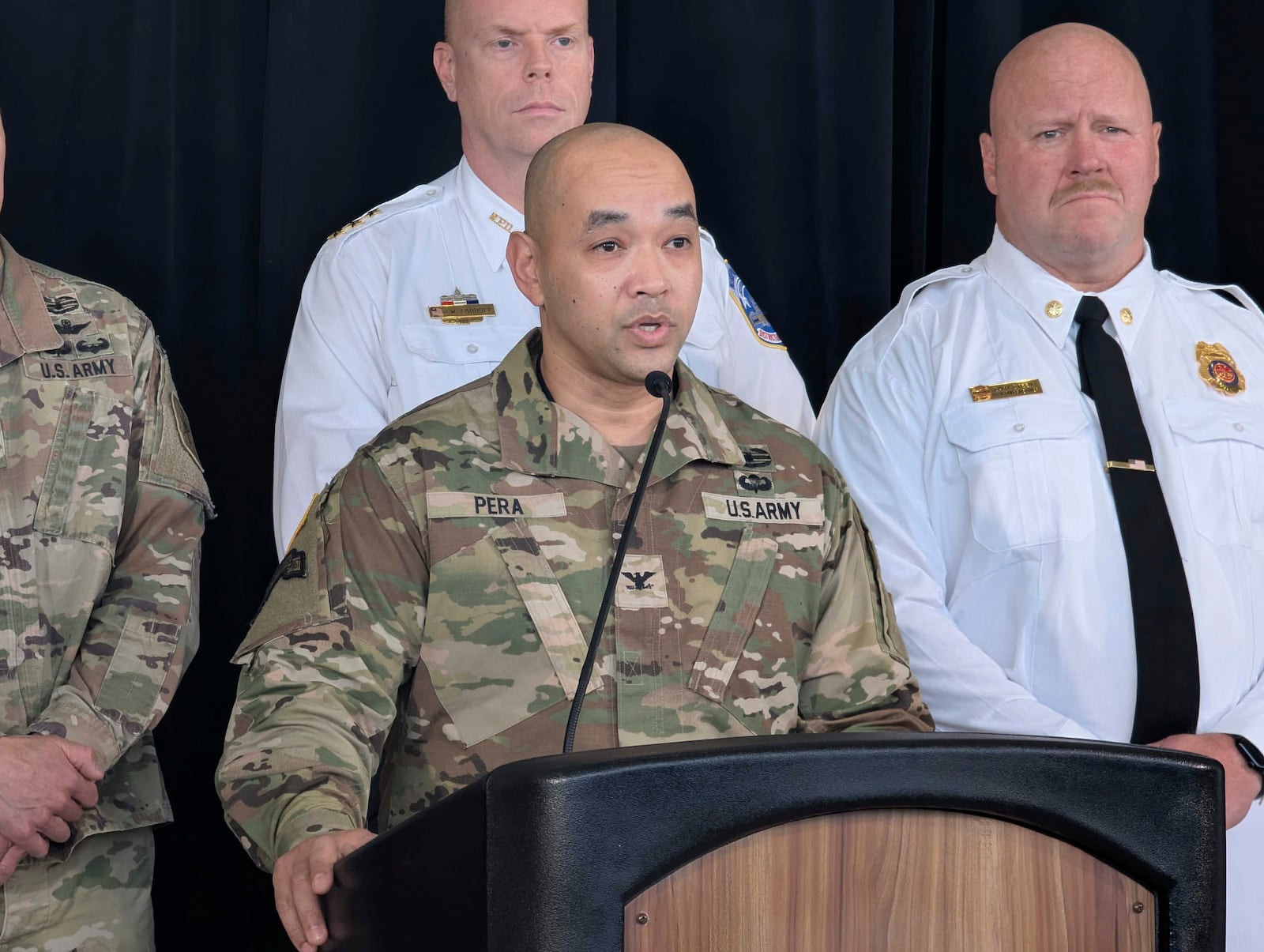 Col. Francis Pera, commander of the U.S. Army Corps of Engineers, speaks as D.C. Fire and EMS Assistant Chief Gary Steen, right, listens during a news conference at Ronald Reagan Washington National Airport Monday, Feb. 3, 2025, in Arlington, Va. (AP Photo/Nathan Ellgren)