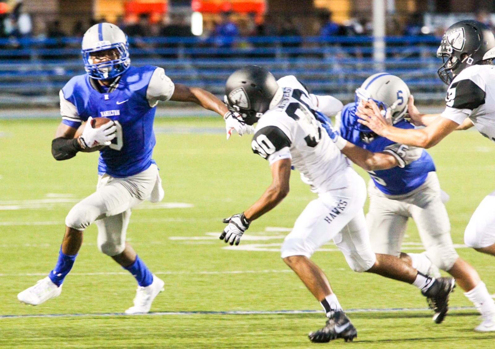 Hamilton wide receiver A'Shon Riggins (3) breaks off a big yardage play during their game agaisnt Lakota East held at Virgil Schwarm Stadium in Hamilton, Friday, Sept. 18, 2015. GREG LYNCH / STAFF