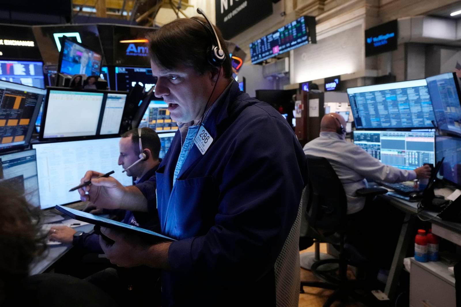 Trader Michael Milano, foreground, works with colleagues on the floor of the New York Stock Exchange, Monday, Nov. 4, 2024. (AP Photo/Richard Drew)