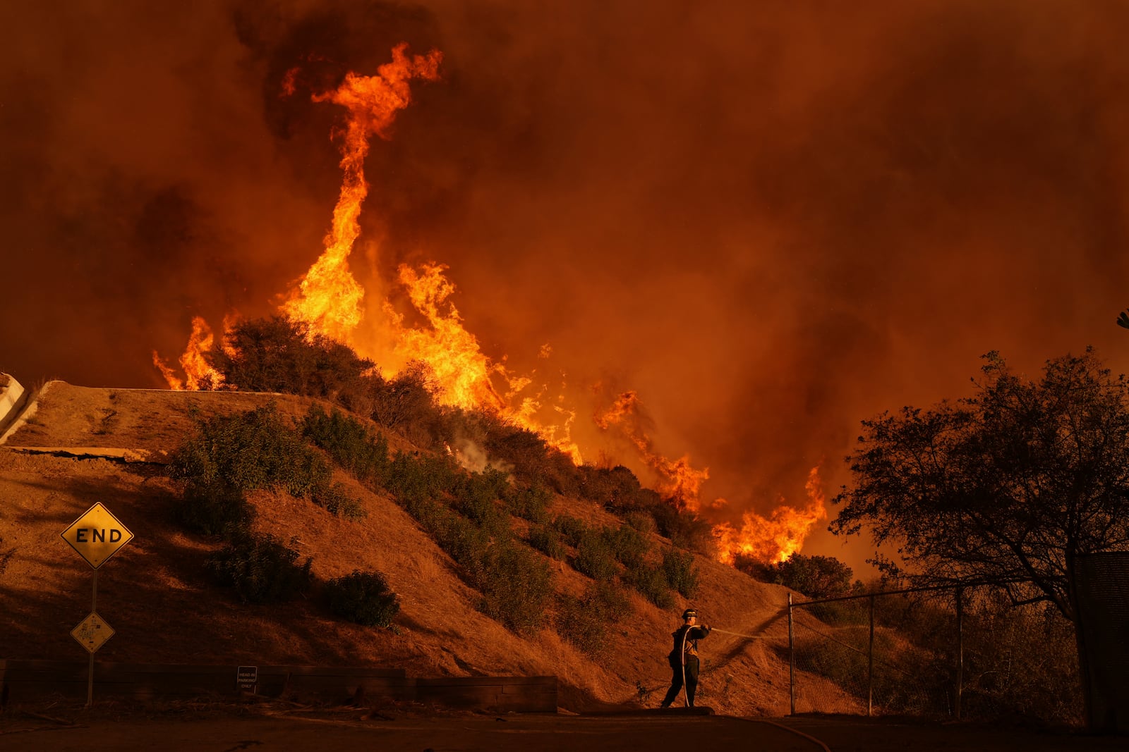 FILE - A firefighter battles the Palisades Fire in Mandeville Canyon Saturday, Jan. 11, 2025, in Los Angeles. (AP Photo/Jae C. Hong, File)