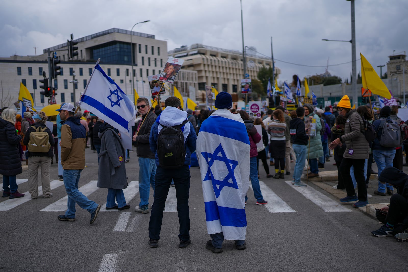 Relatives and supporters of hostages held by Hamas in the Gaza Strip protest outside the prime minister's office in Jerusalem on Tuesday, Feb. 11, 2025. after Hamas announced it would delay a planned hostage release after accusing Israel of violating a fragile ceasefire. (AP Photo/Ohad Zwigenberg)