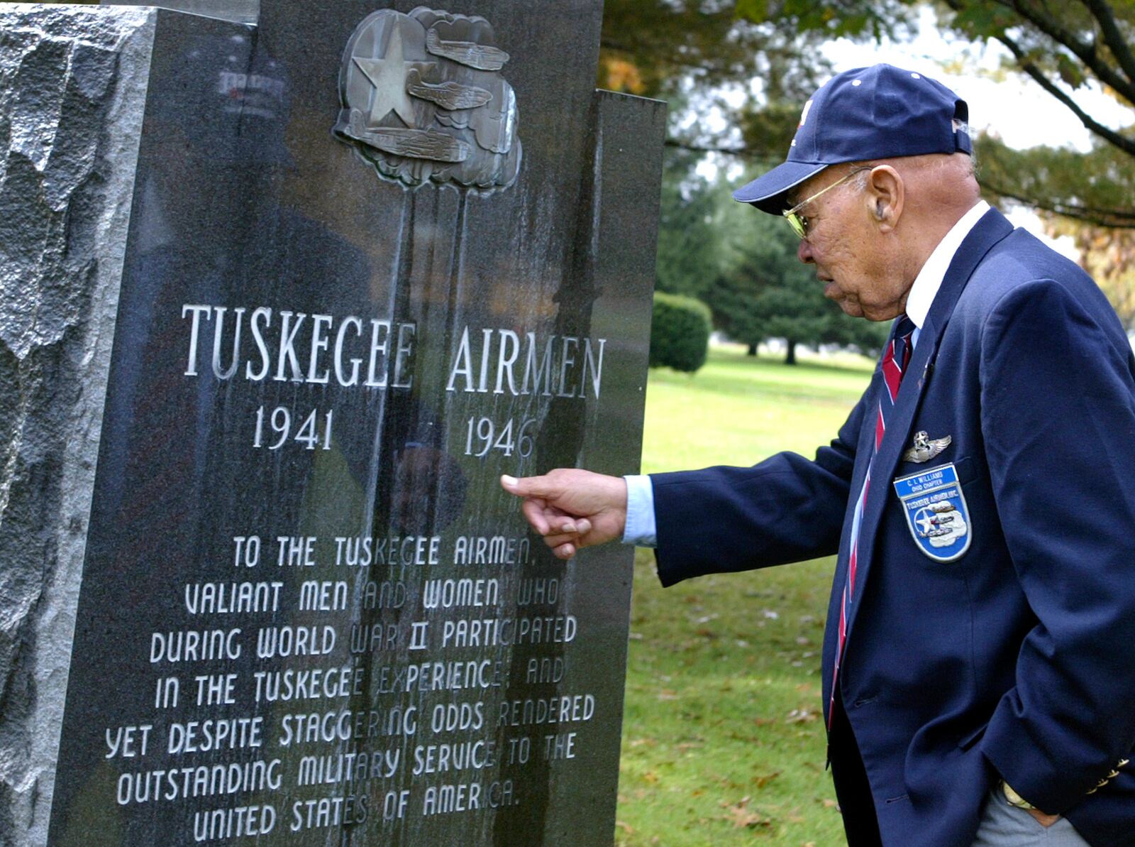 In 2005, Tuskegee Airman C.I. Williams paused for a moment to remember his days as a pilot during WWII as one of the famed African-American flyers. The Airmen pooled their money and had the monument put in the Air Force Museum's Memorial Park. STAFF PHOTO BY BILL REINKE.