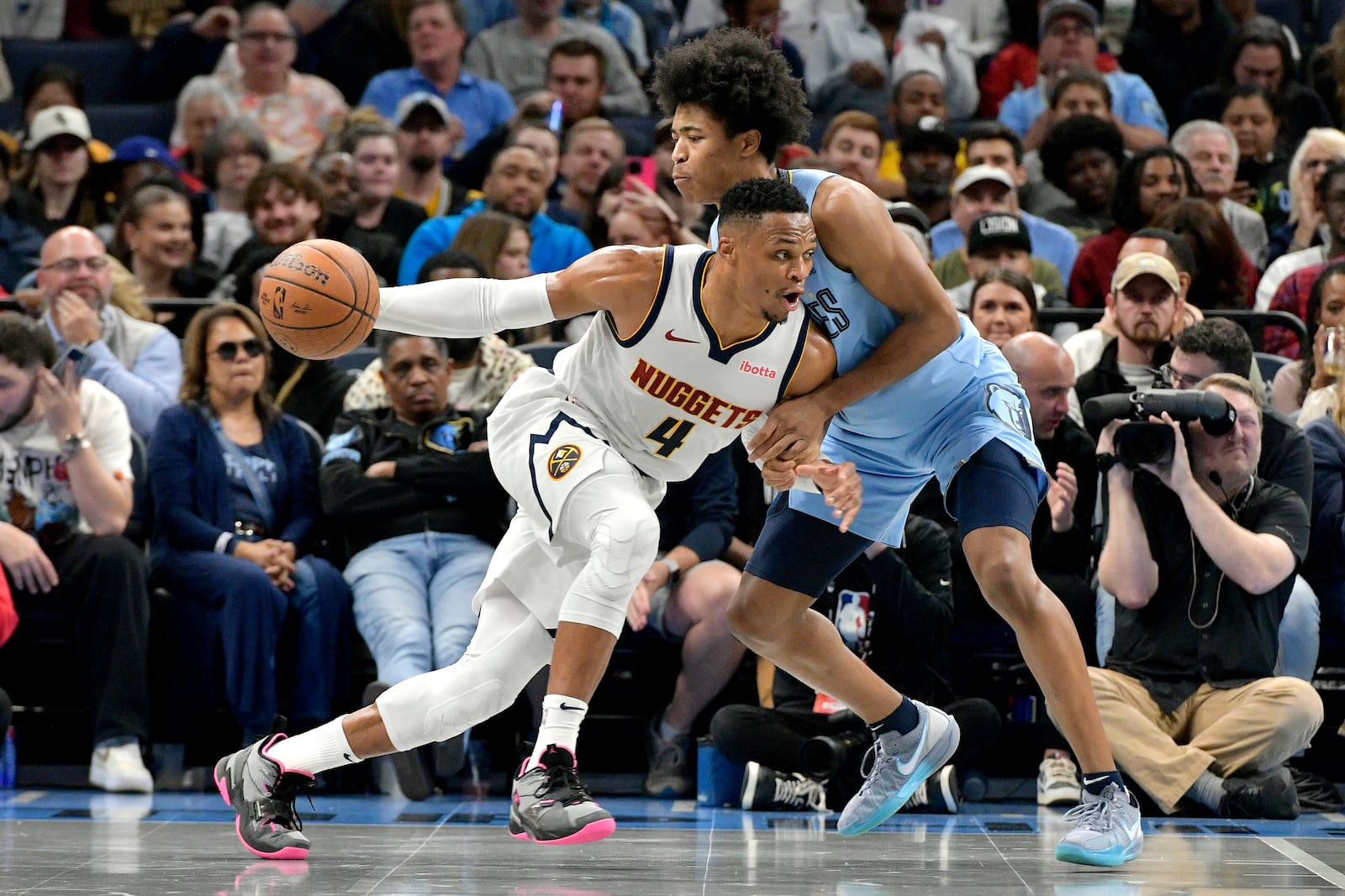 Denver Nuggets guard Russell Westbrook (4) drives against Memphis Grizzlies forward Jaylen Wells in the first half of an Emirates NBA Cup basketball game Tuesday, Nov. 19, 2024, in Memphis, Tenn. (AP Photo/Brandon Dill)